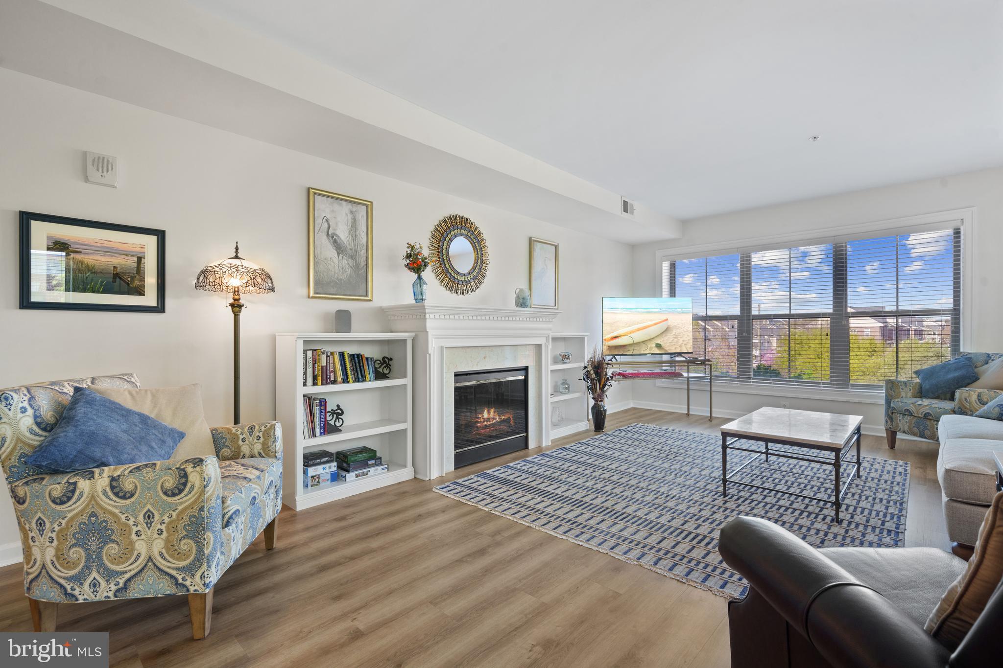 Stunning Corner Unit Condo with Elegant Features and Water Views

Welcome to this beautifully appointed corner unit condo, offering an abundance of natural light through its large windows and peekaboo water views. The elegant foyer entry leads you into an open-concept living space, featuring luxury vinyl plank floors throughout. The spacious kitchen boasts ample cabinetry, granite countertops, and a dedicated dining area, perfect for entertaining. The cozy living room is centered around a charming fireplace, adding warmth and ambiance to the space.

The generously sized primary bedroom includes two walk-in closets with space for organizers and an en-suite bath with a separate stand-up shower, and soaking tub. Bedrooms are equipped with ceiling fans for added comfort. A well-sized laundry room adds convenience and extra storage for all your utility needs. The building offers elevator access and secured entry, providing peace of mind.  Enjoy not only the low maintenance living this unit offers but also the incredible amenities this Marina community has along the water with amazing views you can enjoy daily in every room!!  Updates include  ** Refrigerator and Dryer 1.5 yrs old**  Newer primary bath faucets ** Custom Light Fixtures ** High end quality carpeting in bedrooms ** Unit comes with Storage room and convenient Garage Parking ** Located in close proximity to the Occoquan National Wildlife Preserve, offering excellent walking paths, and just one mile from the VRE (Virginia Rail Express) station, this condo is ideally situated for those who enjoy both nature and convenience.
