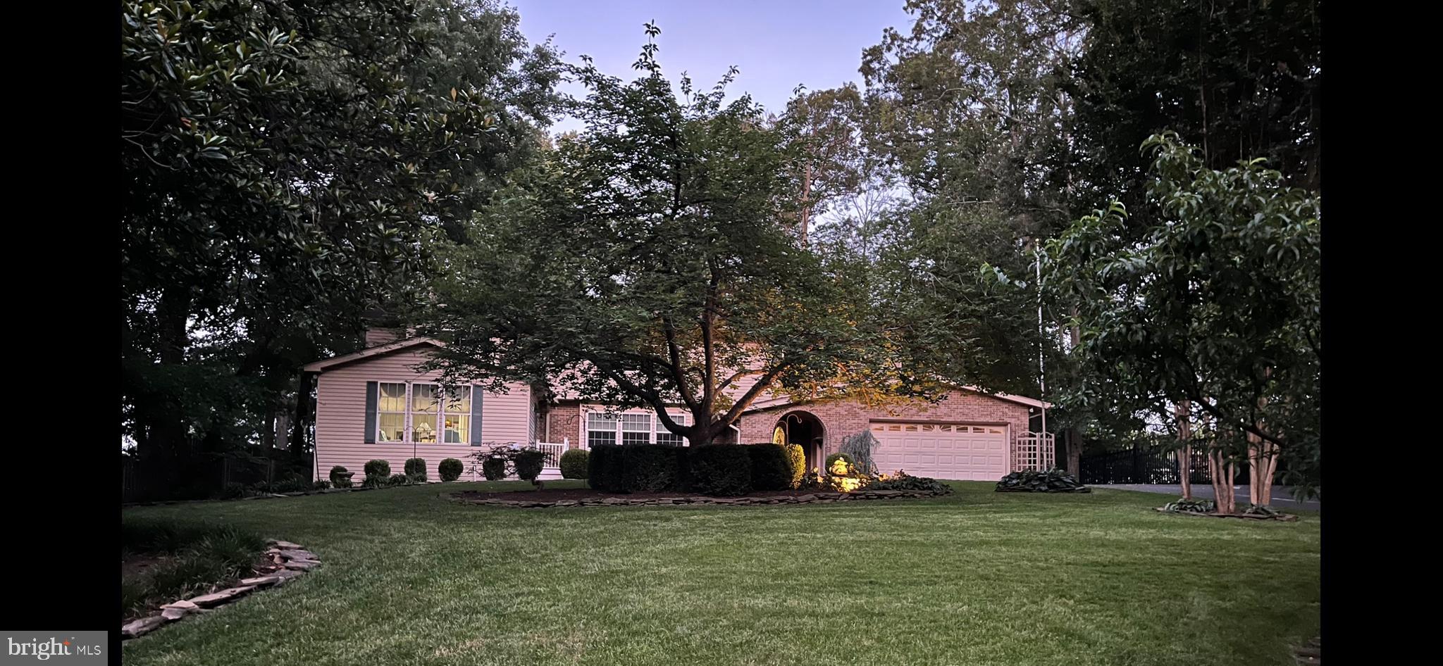 Located in the Esteemed Graham Park Shores Subdivision in Prince William County, this Elegant Home combines Location, Luxury, Convenience and Thoughtfully Designed Floorplan for Multi-Generational Living.  This Exceptional Property combines a Main House with Attached 2 Story In-Law Suite, with Private Entrance.  Sitting on a half-acre lot with Quantico Creek Water Views and no HOA Fees, this House boasts an Expansive 4,683sf of Living Space.  There are 3 Fully Finished Levels, 4/5 Bedrooms, 5 Baths, 4 Fireplaces, 2 Kitchens, Separate Living Room, Dining Room, Music Room, 2 All-Season Sun Patios, 2 Washers & 2 Dryers, Home Security System and a Backyard Oasis with a Lighted, LED Inground Pool & Fountain that can only be described as a Little Piece of Heaven.  

The Main House has a Large Traditional Floorplan featuring Upgraded Modern Conveniences & Materials.  Perfect for entertaining, the Kitchen features a Large Gathering Island w/Electrical Outlets, comfortably accommodating 6-8 people, Stainless Steel Appliances, including a New Side by Side Frigidaire Refrigerator, New LG Dishwasher, LG Self-Cleaning Double Oven, and New Built-In Trashcan.  The kitchen is flanked on either side with 2 All-Season Sun Patios with French Doors overlooking the Pool.  With 4 Fireplaces, it easy to find a room to get cozy or relax in.  Attention to Detail is not lost within each of the Rooms, Showcasing Hardwood Floors, Crown Molding, Trey Ceilings, Recessed Lighting, 10 Ceiling Fans, Fireplaces and Arched Windows (Energy-Efficient).  The Amenities continue Upstairs, but the Master Bedroom is a sight to be seen.  This Enormous Bedroom with Walk-In Closet has an Attached Bathroom Designed for Modern Day Kings and Queens.  Through an Arched Entrance and Surrounded in Granite & Marble, the Master Bath has Granite Double Sinks Lighted by 2 Chandeliers, a Granite Make-Up Vanity, a Granite & Marble Walk-in/Seated Shower and Elegant “Clawfoot” Soaking Bathtub.  New Carpet & Remodeled 2nd Full Bath completes the Upstairs 3 Bedroom Level.

The 2 Story In-Law Suite Addition offers a Private Entrance into a Large Living Room with Hardwood Floors, a Fireplace, a Kitchenette with Granite Countertops, Refrigerator and Dishwasher, included Table and Chairs and Same Level Bedroom. The Master Bath continues with Granite Countertops, a Granite Makeup Vanity Nook, Walk-in Shower and Handicap & Wheelchair Accessible Widened Doorways.  A Full-Size Washer & New Dryer are housed in a Main Level Closet.  The Large Upstairs Bonus Room can be enjoyed as a 2nd Bedroom, a Home Gym, Media Room or Office.  Off the Bonus Room is a Private, Outdoor 2 Person Deck Poolside, with Woods & Water Views.

Lower-Level Amenities include a Fully Finished Walk-Out Basement with Half Bath, Office, Exercise/Fitness Room, transitioning into a Media or Game Room with included Pool/Ping Pong Table, an All-Brick/Stone Fireplace & Hearth, Wet Bar with Sink, Mini-Fridge, Cabinetry & Storage, a Large Laundry Room with 2 Story Laundry Chute & Workstation, New Washer & Dryer, a Navien Tankless High-Efficiency Water Heater.  Leading outside, the Basement Walk-Out opens to an Enclosed Hot Tub or Pool Changing Room.  

Indulge in a Resort-Style Vacation Getaway, enjoying the Custom Designed, In-Ground Pool with LED Mood Lighting & Bubbling Fountain, an All-Brick Pool Changing House & 4 Person Rotunda Gazebo.  The Outdoor Pool Chairs & Chaise Loungers encircle the Cement-Paved Pool Area Adding Function and Convenience; Perfect for Entertaining.  2 Charming Barn-Styled Storage Utility Sheds are Nestled in the Background, along with 2 additional fenced Areas for the four-legged family members to play.  Other Features include a 2 Car Garage w/Ceiling Storage, 8 Car Paved Driveway, New Chamberlain Garage Door Opener, Underground Water Sprinkler System, Manicured Front Lawn w/30yo Cherry Tree.  Property is located near Rt1, I-95, Quantico Marine Base, FBI Academy, shopping & schools.