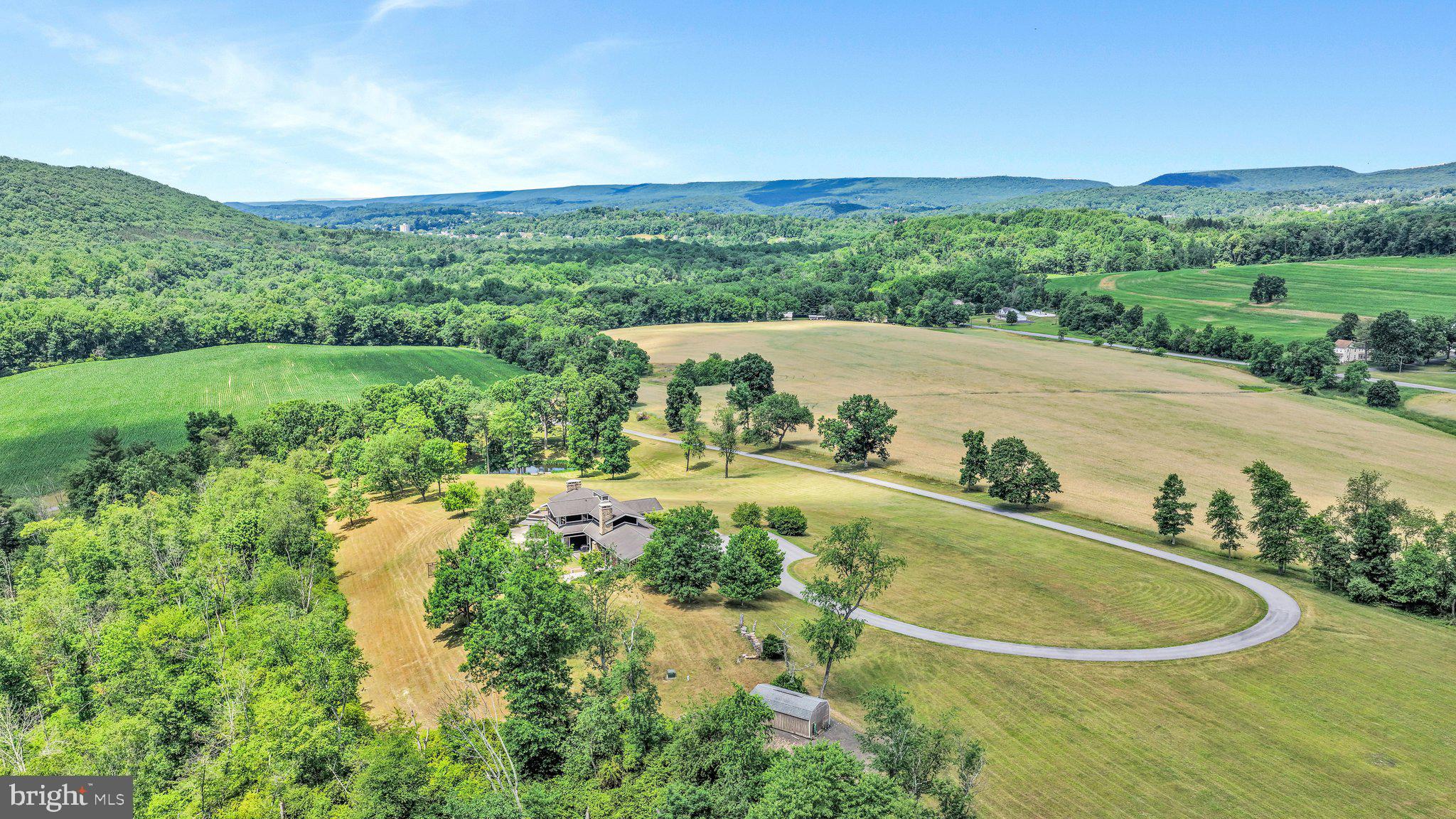 Welcome to your own private paradise! Tucked away at the end of a winding half-mile paved driveway, this extraordinary custom-built contemporary home sits on nearly 93 breathtaking acres in the Schuylkill Haven Area School District, including approximately 34 tillable acres. Surrounded by panoramic views, abundant wildlife, and complete privacy, this one-of-a-kind estate offers the perfect blend of luxury, recreation, and peaceful country living.

As you make your way up the scenic driveway, you’ll pass your own private pond, often visited by deer, wild turkey, and other wildlife, creating a truly unforgettable approach to the home.

This magnificent 6,000+ square-foot custom-built contemporary home welcomes you with an impressive foyer featuring soaring walls of glass that immediately showcase the spectacular views stretching for miles. Sliding glass doors lead to a covered patio featuring a stunning floor-to-ceiling stone, wood-burning fireplace—the perfect place to enjoy your morning coffee or unwind on crisp fall evenings while taking in the brilliant colors of the changing leaves across the countryside.

The breathtaking great room is the heart of the home, featuring soaring vaulted wood ceilings, recessed lighting, massive walls of glass, and a dramatic floor-to-ceiling stone wood-burning fireplace. A beautiful open staircase leads to the luxurious primary suite while maintaining the home’s open and inviting design.

The custom eat-in kitchen is designed for both everyday living and entertaining, offering beautiful custom cabinetry, granite countertops, a commercial-sized propane range with double ovens and a center griddle, and all appliances included. Whether preparing family dinners or hosting holiday gatherings, this kitchen is sure to impress.

The main level also features two spacious bedrooms, each with its own full bathroom, allowing family and guests to enjoy both comfort and privacy while taking in the incredible views from nearly every room.

The spectacular primary suite is a true retreat, complete with a spacious bedroom, an enormous walk-in closet featuring custom-built cabinetry and drawers, a luxurious en-suite bath, and private access to a low-maintenance Trex deck overlooking the breathtaking property.

Offering over 6,000 square feet of finished living space, this remarkable home features 3 bedrooms, 4.5 bathrooms, and the potential for additional bedrooms in the finished lower level. The lower level is equally impressive, featuring expansive walls of glass, a large family room, study, workout room, and an entertaining area complete with a bar—perfect for hosting family and friends.

Additional amenities include radiant floor heating, a whole-house Generac generator, an attached three-car garage, raised flower beds, and propane lines already installed on both outdoor patios to provide continuous fuel for your grills during cookouts and special occasions.

Outdoor enthusiasts will never want to leave. Hunt on your own land, fish in your private pond, explore nearly 93 acres of rolling countryside, or simply relax while taking in some of the most spectacular views the area has to offer. With approximately 34 tillable acres, the property also offers enough open, level ground for a potential private landing strip, making it an incredible opportunity for aviation enthusiasts (subject to applicable approvals and regulations).

Although you’ll feel miles away from everything, this incredible property is conveniently located just minutes from Route 61, shopping, restaurants, hiking trails, and bicycle trails.

This is more than a home—it’s a private estate where luxury, recreation, and nature come together. Opportunities like this are exceptionally rare. Schedule your private showing today before this one-of-a-kind masterpiece is gone!