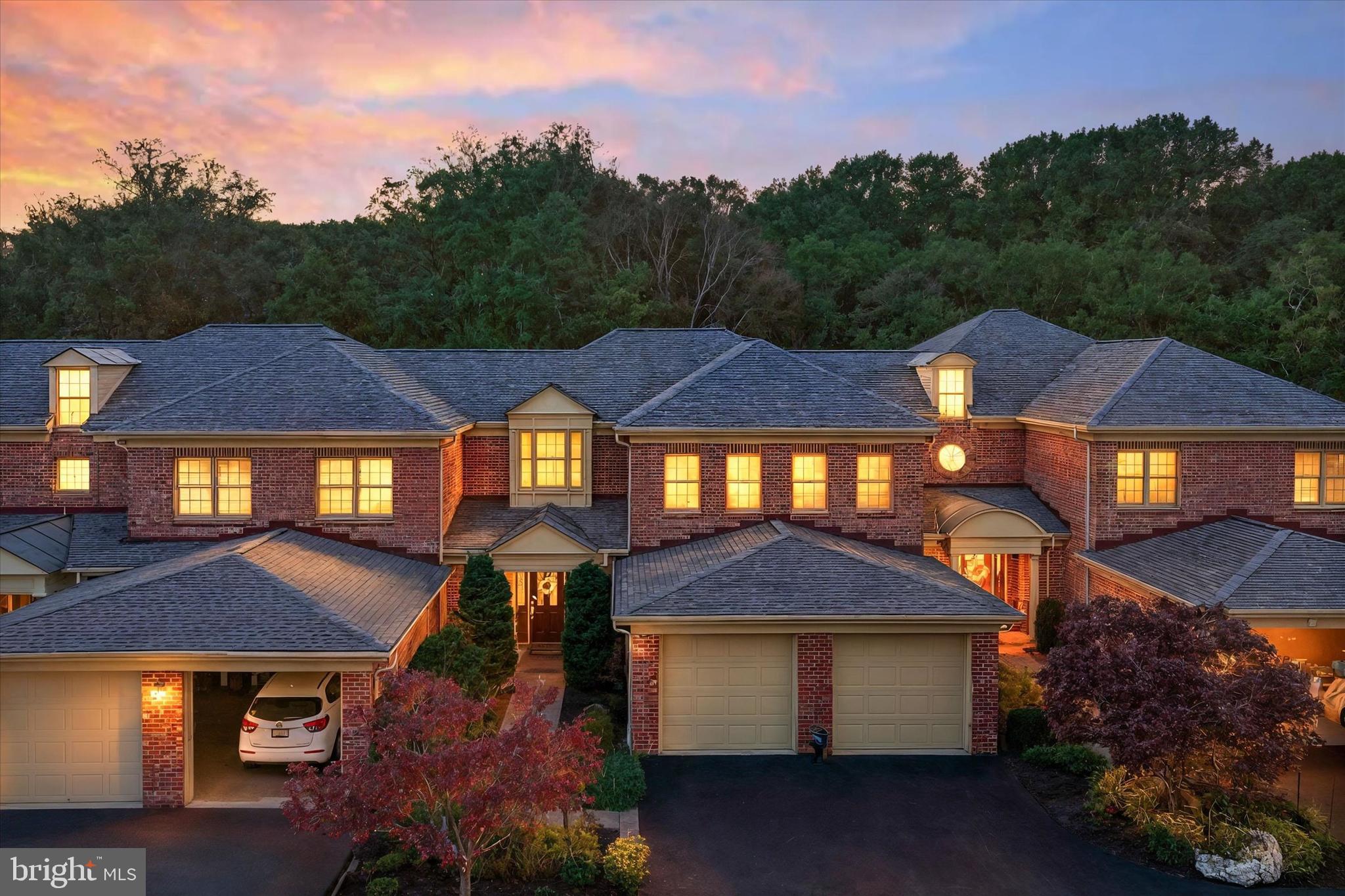 NEW PRICE!!  LOCATED IN GLENANGUS!   Elegant Brick Carriage Villa Home in Glenangus. Located in the prestigious Glenangus community, adjacent to the Maryland Golf & Country Club, this fully brick carriage villa offers refined living with the convenience of HOA-covered lawn and landscaping maintenance, providing a truly low-maintenance lifestyle in a high-quality neighborhood.  An impressive two-story foyer welcomes you into a home featuring hardwood floors throughout and thoughtfully designed living spaces. The main level offers a formal dining room with coffered ceilings and a bright sit-in sunroom with soaring 10-foot ceilings. The gourmet kitchen is beautifully appointed with cherry cabinetry, all appliances, a large pantry, and extensive storage, and opens to a spacious family room with coffered ceilings and a gas fireplace, ideal for both everyday living and entertaining.
The main level also includes a large laundry room with a washer, dryer, and utility sink. The Luxury Bedroom Suite features a luxurious bath with double sinks, a separate soaking tub and shower, and a generous walk-in closet. Two additional spacious bedrooms with a family full hall bath. The fully finished walk-out lower level offers exceptional additional living space, including a family room with a gas fireplace, a game room with a wet bar, a full bathroom, and an additional finished storage room with sink and multiple cabinets, ideal for hobbies, entertaining, or flexible living needs. A surround sound system with all equipment is conveyed.  Outdoor living is enhanced by a large deck overlooking a beautiful wooded lot, as well as a walk-out patio from the lower level. Additional features include a two-car garage, a New Roof,  HVAC replaced approximately 2.5 years ago, and a hot water heater replaced approximately 3 years ago.  This exceptional home combines elegance, comfort, and convenience in one of the area’s mos
