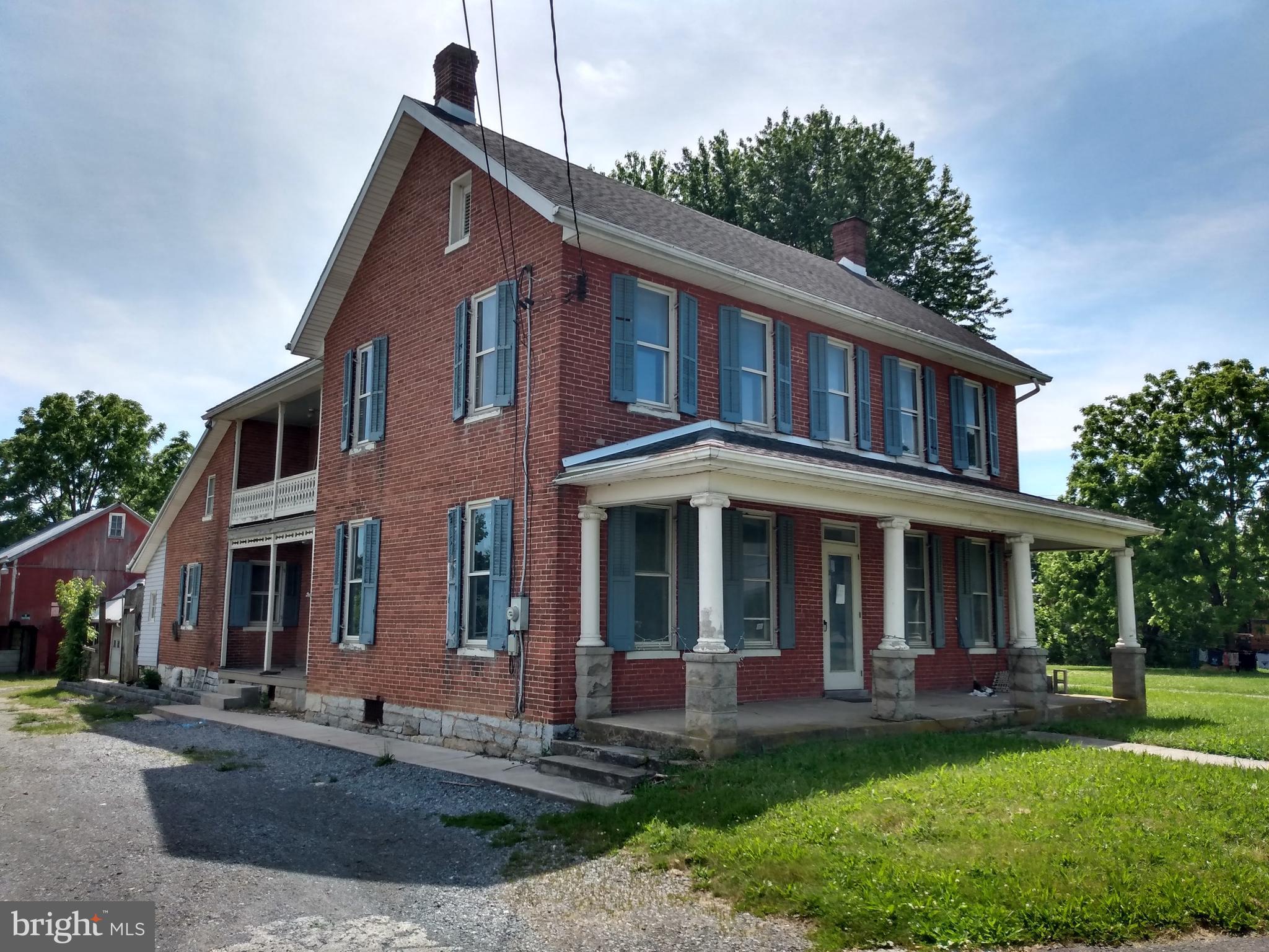 BRICK FARM HOUSE WITH BARN!  This 3000 square ft 4 bedroom 1.5 bath home features: updated kitchen with cherry cabinets & granite counters; hardwood floors through out; huge family room with decorative fireplace; additional living room & den; main floor laundry room with half bath; large master bedroom with walk-in closet & balcony access; three additional bedrooms; updated full bath with beautiful vanity & cabinets; and so much more.  Outside features: multiple porches; summer kitchen/smokehouse; deck; patio; potting shed; wood shed; detached 2 car garage; barn with stables & large hayloft; huge equipment pavilion; and more.  Additional updates include: roof; siding; and heatpumps.  Located in the lovely Guilford Springs Area and setting on over an acre of land with room for your RV; boat; ATV and/or other toys.