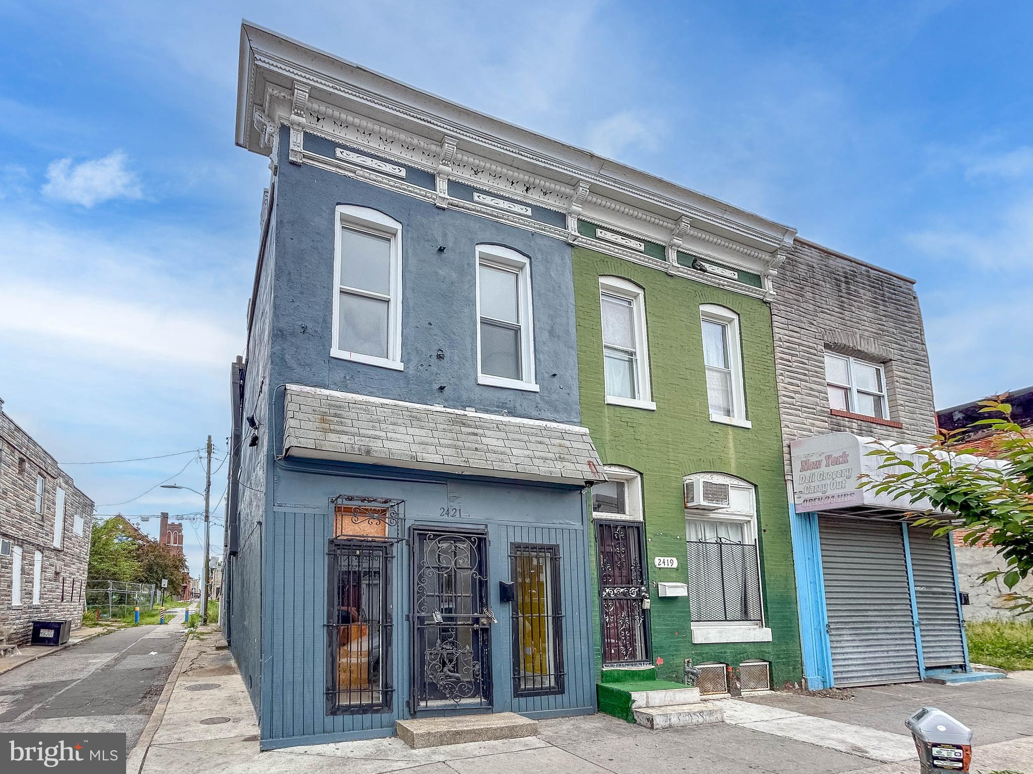 List price is opening bid. Online Auction Only! Bidding begins Saturday, June 4th, and ends Tuesday, June 9, 2026 at 11:30AM. 2421 E. Monument Street is a brick-front end-of-group townhouse located in the McElderry Park neighborhood of East Baltimore. Configured as a mixed-use commercial and residential property, the building is zoned C-1 Neighborhood Business District, offering flexibility for a variety of potential residential, commercial, or investment uses. The property is currently vacant and presents an excellent opportunity for an owner-occupant, investor, or small business user. Conveniently located near Johns Hopkins Hospital, downtown Baltimore, and Patterson Park, the property benefits from strong commuter access and proximity to neighborhood amenities. The main level is configured as commercial space and features an open floor plan suitable for retail, office, studio, or other professional uses. Interior finishes include a combination of carpet and wood-style flooring, along with forced hot air heating, a gas water heater, and a convenient half bathroom. The upper level serves as a residential component and is accessible through a private rear entrance within the fenced outdoor area. Residential features include an exterior balcony, a potential kitchen area with laminated wood flooring, two bedrooms, and one full bathroom.

Located within the C-1 Neighborhood Business District, the property offers potential flexibility for neighborhood-oriented commercial activity while maintaining compatibility with surrounding residential uses. Its mixed-use configuration and strategic East Baltimore location make it well suited for rental income potential, live-work arrangements, or future redevelopment opportunities. The property is located within the C-1 Neighborhood Business District, which is intended to support pedestrian-oriented commercial corridors and neighborhood-serving businesses. According to the Baltimore City Zoning Code, the district is designed to ensure compatibility between residential and commercial uses, maintain appropriate commercial scale, and address the unique characteristics of smaller commercial sites. Situated in East Baltimore’s McElderry Park neighborhood, the property benefits from close proximity to major employers, public transportation, neighborhood amenities, and ongoing community redevelopment initiatives. Note: 2419 E. Monument St. is also being offered for auction on the same date at 11:00am.