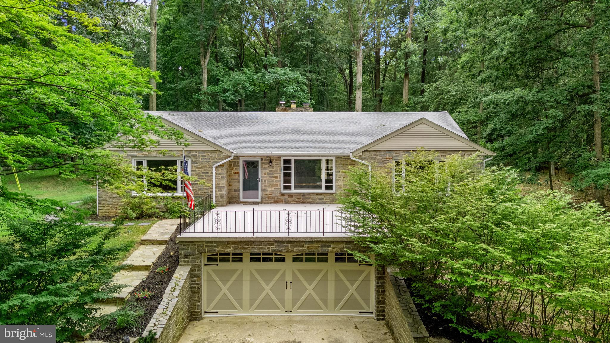 Charming stone rancher nestled on a private lot, offers the perfect blend of charm, comfort, space & nature. Five Bedrooms, one currently being used as an additional closet, 2 full and 1 half baths on the main level. Large, inviting, living room with hardwood floors & fireplace, flows seamlessly into the dining room & eat in kitchen, perfect for entertaining. Lower level offers additional family room area and plenty of storage in the utility room. Front and rear patio/deck areas, 2 car garage, private wooded lot & more!