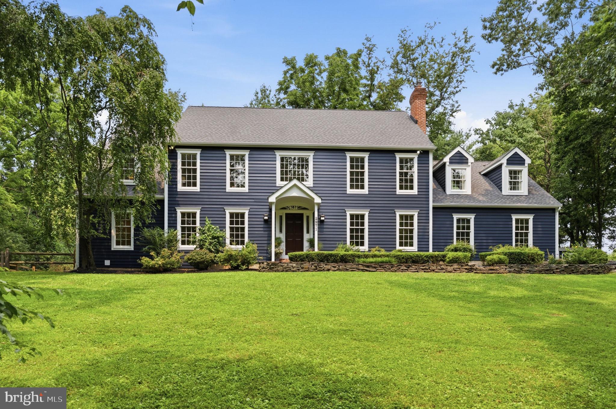 2971 Comfort Rd. is the one you've been waiting for in the award winning New Hope-Solebury SD! 
This beautifully updated Colonial-style residence sits back on a quiet lot at the end of a private lane on one of New Hope's most coveted roads. With a major renovation just completed in 2026 (Interior and Exterior), this home offers 3,681 sq. ft. of luxurious living space, featuring 4 spacious bedrooms and 2.5 beautifully appointed bathrooms-  plus over 700 sqft of finished space in the basement. Step inside to find a blend of classic charm with modern sophistication as you enter a 2 story foyer with an elegant curved staircase. The heart of the home is the new gourmet kitchen, equipped with high-end appliances including a Monogram refrigerator, built-in range, double wall ovens, and a stylish oversized island perfect for culinary creations. Cozy up in the living room by one of the two fireplaces, adorned with brick and marble finishes, or unwind in the cozy library tucked back off the main den. Upstairs, you will find a gorgeous primary suite that includes a large sitting room with a balcony that overlooks the side yard.  The newly updated primary bath feels like a spa right in your own home. All hardwood floors have been refinished and new carpeting installed in each bedroom. The exterior is equally captivating, featuring new lush landscaping & hardscaping and serene garden views from each window. Enjoy outdoor gatherings on the patio, surrounded by mature trees that provide privacy and shade. The property also includes an oversized attached 3-car garage and extended driveway (newly completed) for convenience and ample parking for entertaining. Experience the perfect balance of indoor elegance and outdoor beauty in this turnkey property, where every detail has been thoughtfully curated for your enjoyment. The completed upgrades and improvements list is extensive. Please review the full document posted in MLS.