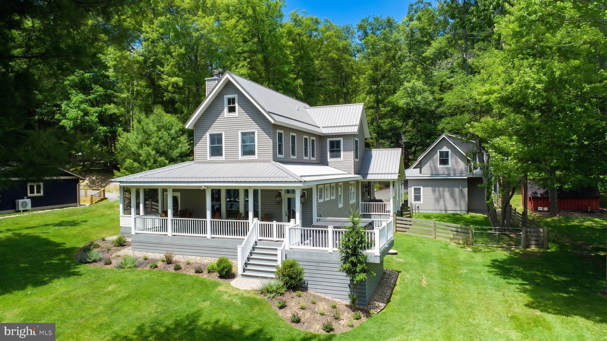 Enjoy the best in lake living with this ready to move in and enjoy 5 BR 3.5Bath craftsman style home and lakefront property.  

Situated in a desirable quiet cove on the southeastern section of Deep Creek Lake, the level lakefront parcel offers the perfect getaway setting and unobstructed views of the lake.  The partially wooded lot provides the perfect combination of shade and open lawn area for just about any outdoor activity.   The impressive dock area includes 2 slips and plenty of sitting space to take in the peaceful lake views.

The well thought out floor plan has no wasted space.  Every room and living area was carefully designed to maximize lake living while limiting maintenance and upkeep.  The main floor includes abundant window space and high ceilings to promote plenty of natural lighting throughout.   The open kitchen/dining area offers plenty of space for gathering and meal preparation.   The living room offers the perfect space to sit back and relax. The spacious main level primary bedroom suite offers a walk in closet, double bowl vanity and walk in shower.   There is also a tidy office space if you absolutely need to get some work done.  

The second floor includes 3 bedrooms with high ceilings, plenty of window space and there is even a vanity with running water if you need to freshen up.  There is even a storage area that can also be used as a play area for the little ones. 

An oversized 2 car garage carriage house includes a private living space above including a beautiful bathroom with walk-in tile shower, a kitchenette and private balcony.   The garage area has oversized doors that provide the opportunity to store boats and or allow taller vehicles to be stored.  

When it's time to relax, you have options.  Take in the lake views while enjoying a fire from a beautiful stone fireplace while in the main living room or on the spacious attached screened porch.  Or, sit back on the covered lake side porch  before or after enjoying a dip in the lakeside hot tub.   And don't forget the shoreline  and dock areas as they are both offer ideal spots to get away from it all.  

Quality and convenience are two words that best describe the structures.   You can see it both inside and out.  Beautiful high quality materials were selected and used throughout.  You can feel it as you walk through the home and carriage house.   You'll experience it as you open and close doors.   

When it comes to exterior maintenance, this property is well ahead of the competition.  With metal roofing, synthetic decking, and high quality low maintenance siding, you won't be wasting your away time worrying about painting and upkeep.  The paved driveway with plenty of parking space is in excellent condition.   The property also offers fenced areas to keep children and pets safe.   

The property is also located within minutes of the highly rated Thousand Acres Golf Club which also offers pickleball and tennis courts.