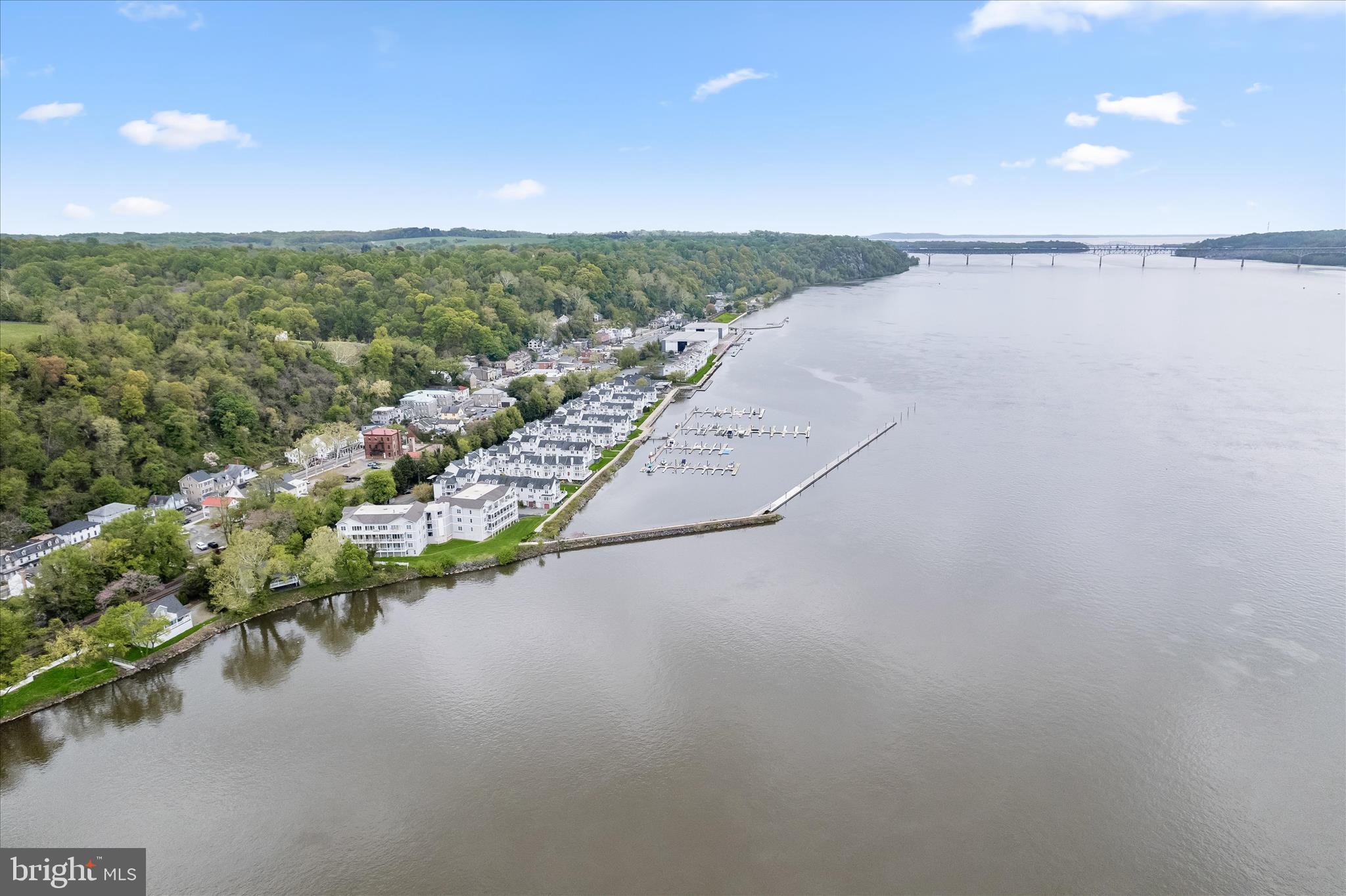 Opportunities like this rarely come along. This hard-to-find 3-bedroom, 2-bath penthouse waterfront condo in historic Port Deposit offers an exceptional blend of space, style, and scenery, all from a desirable top-floor location.
Set within beautifully maintained grounds, residents enjoy exclusive access to a private pier and the ease of a building elevator, creating a lifestyle that feels both relaxed and refined. A private garage, another highly desirable amenity, adds both convenience and value. Inside, the home shows like a model with an on-trend neutral color palette that complements every space. The elegant foyer welcomes you with newer wood-inspired luxury vinyl plank flooring and leads seamlessly into the gourmet kitchen. Thoughtfully designed, the kitchen features newer stainless steel appliances from 2021, granite countertops, a peninsula island perfect for casual dining, a designer backsplash, and a spacious pantry.
The open floor plan continues into a bright dining area and living room that flows effortlessly into the stunning sunroom. Here, panoramic waterfront views take center stage, creating a peaceful retreat for everyday living. Step out onto the private balcony and take in breathtaking sunrises, glowing sunsets, and gentle breezes off the water.
The primary bedroom suite is a true haven, positioned to capture serene water views and complete with a walk-in closet and an en suite bath featuring a garden tub designed for relaxing soaks. Two additional bedrooms offer flexibility for guests, a home office, or hobbies, and are served by a convenient dual-entry full bath. A finished laundry room and the newer AC system add to the comfort and practicality of this well-appointed home. 
Located within a short distance to Tomes Landing and just minutes from local favorites like Lee's Landing Dock Bar, along with nearby destinations such as Hollywood Casino and Great Wolf Lodge, this home offers both tranquility and convenience.
If you have been searching for a rare combination of true three-bedroom living, direct waterfront lifestyle, and the added benefit of a private garage, this exceptional condo delivers.