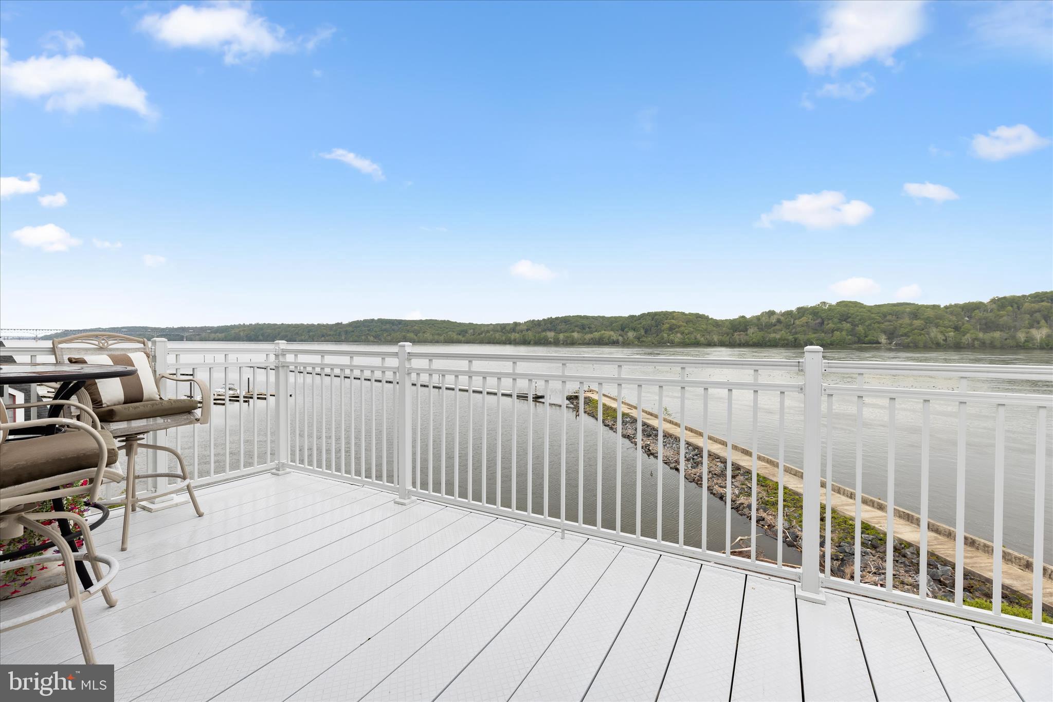 Opportunities like this rarely come along. This hard-to-find 3-bedroom, 2-bath penthouse waterfront condo in historic Port Deposit offers an exceptional blend of space, style, and scenery, all from a desirable top-floor location.
Set within beautifully maintained grounds, residents enjoy exclusive access to a private pier and the ease of a building elevator, creating a lifestyle that feels both relaxed and refined. A private garage, another highly desirable amenity, adds both convenience and value. Inside, the home shows like a model with an on-trend neutral color palette that complements every space. The elegant foyer welcomes you with newer wood-inspired luxury vinyl plank flooring and leads seamlessly into the gourmet kitchen. Thoughtfully designed, the kitchen features newer stainless steel appliances from 2021, granite countertops, a peninsula island perfect for casual dining, a designer backsplash, and a spacious pantry.
The open floor plan continues into a bright dining area and living room that flows effortlessly into the stunning sunroom. Here, panoramic waterfront views take center stage, creating a peaceful retreat for everyday living. Step out onto the private balcony and take in breathtaking sunrises, glowing sunsets, and gentle breezes off the water.
The primary bedroom suite is a true haven, positioned to capture serene water views and complete with a walk-in closet and an en suite bath featuring a garden tub designed for relaxing soaks. Two additional bedrooms offer flexibility for guests, a home office, or hobbies, and are served by a convenient dual-entry full bath. A finished laundry room and the newer AC system add to the comfort and practicality of this well-appointed home. 
Located within a short distance to Tomes Landing and just minutes from local favorites like Lee's Landing Dock Bar, along with nearby destinations such as Hollywood Casino and Great Wolf Lodge, this home offers both tranquility and convenience.
If you have been searching for a rare combination of true three-bedroom living, direct waterfront lifestyle, and the added benefit of a private garage, this exceptional condo delivers.