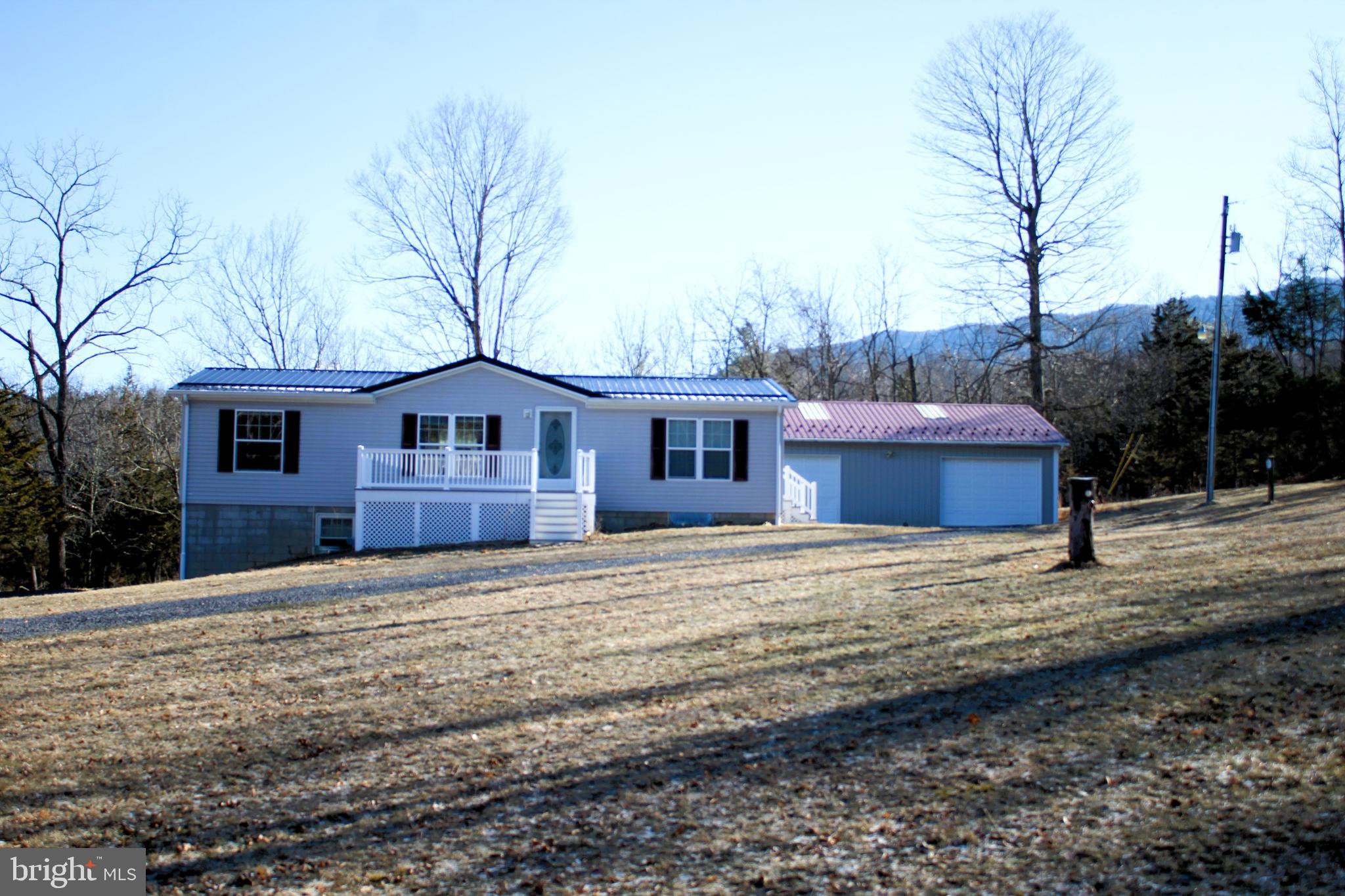 Ranch Modular in a private setting on 2.65 acres, full basement and an additional 30 x 40 detached garage.  This home has 3 bedrooms, 2 bathrooms, new hardwood laminate flooring throughout, open floor plan, giving you lots of time with family.  Private well/septic, new water softener system in the basement.  New metal roof was installed in 2022.  Just minutes from the Village of Riverton and Seneca Caverns.  This home is being sold with furnishings and AS-IS, move in ready.