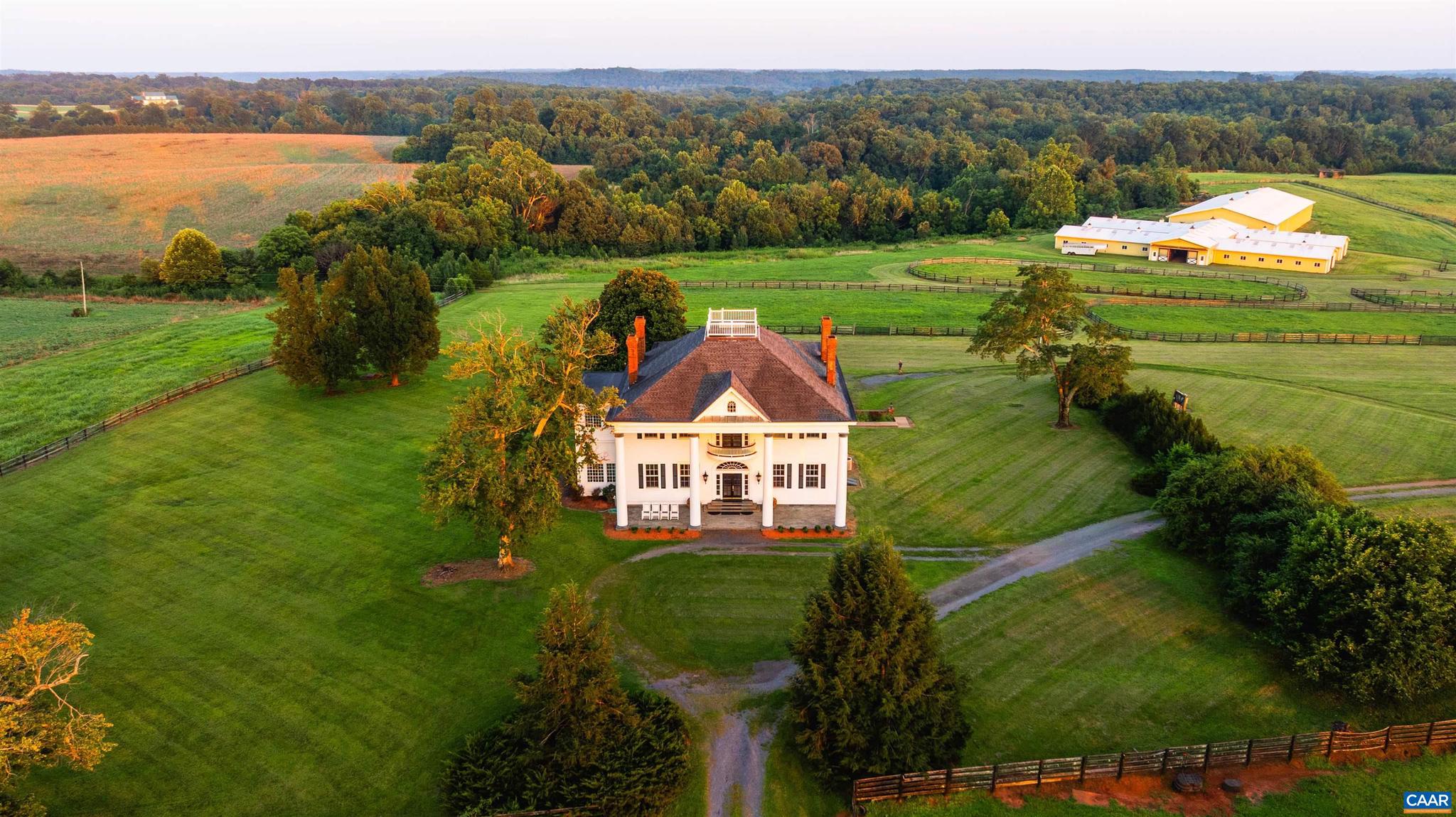 Greenfields Farm spans 753 acres just outside historic Scottsville, VA. A rare blend of rolling pasture, mature timber, and rich history, the property features a 1904 Colonial Revival main house with original architectural detail, a grand spiral staircase, arched transoms, and sweeping views from the widow?s walk. The residence offers copious amounts of living space, with three separate apartments and a caretaker?s home providing options for guests, staff, or extended family. Formerly a working horse farm, Greenfields includes fenced paddocks, a spring-fed creek, a stocked pond, a lake, and five wells. Equestrian facilities include a stable with 48 stalls, an indoor arena, a tack room, foaling stalls, grooming bays, hay storage, offices, and wash bays. Additional improvements include two equipment barns, grain silo, dog kennels, riding trails, and four gated entrances. With ties to Governor Wilson Cary Nicholas and Lady Astor, Greenfields is a legacy estate of rare scale and beauty.