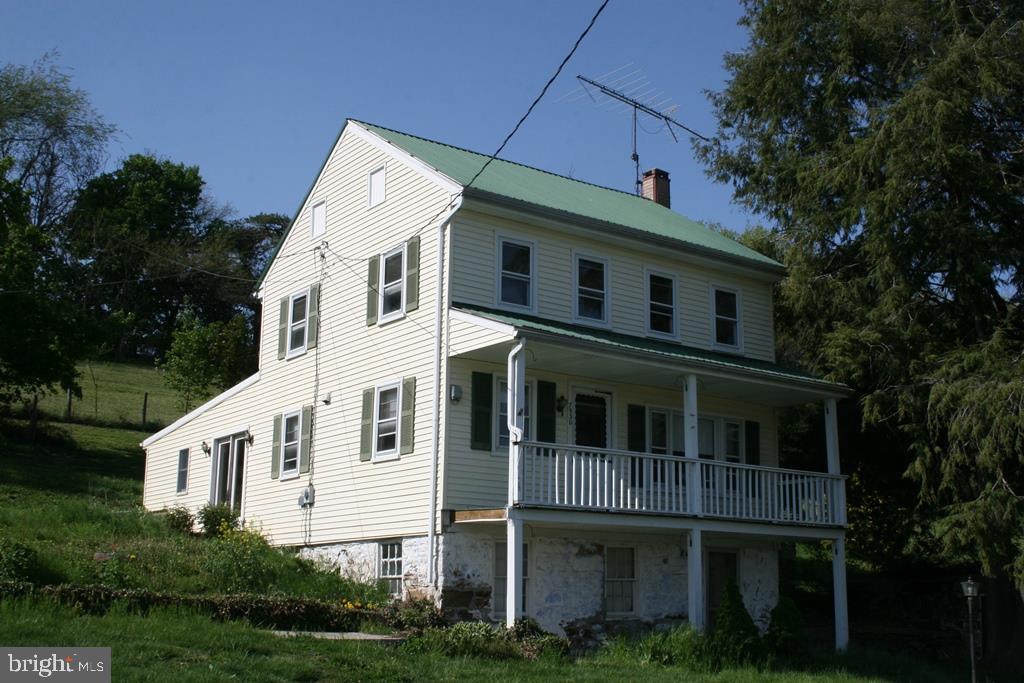 Farmette on 4.38 acres with bank barn and out buildings.  1st floor master bedroom & bath addition w/ handicap tub/shower was used as in-law qtrs.  Updated kitchen. Live on the 1st floor while you renovate the 2nd floor. 2nd floor rehab is started. Walk-out basement. New septic system. New stairway.  Newer roof and furnace.  Fruit trees. Sold "As Is".
