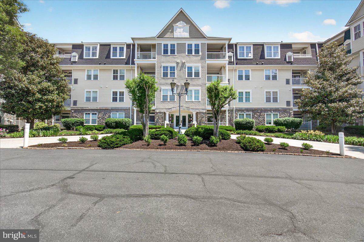 Nestled in the sought-after Worman’s Mill community, this beautifully maintained 2-bedroom, 2-bathroom condo offers the perfect blend of comfort, convenience, and low-maintenance living. Surrounded by beautifully landscaped grounds and scenic walking paths, this inviting home provides a peaceful retreat just minutes from shopping, dining, and all that downtown Frederick has to offer. Step inside to discover a bright open-concept layout featuring newer luxury vinyl plank flooring throughout, a cozy gas fireplace, and tasteful updates including stainless steel door handles, updated lighting and upgraded brushed nickel faucets. The well-appointed kitchen has been refreshed with new granite countertops, new stainless steel appliances, and has a pantry for added storage, seamlessly flowing into the spacious living and dining areas—perfect for both everyday living and entertaining. Just off the kitchen, a versatile bonus space offers endless possibilities as a home office, breakfast nook, or sitting area. Enjoy peaceful mornings with coffee or relaxing evenings on the private patio overlooking the tranquil community setting. Additional highlights include a reserved garage parking space, a separate storage unit for seasonal items and extra belongings, and the rare opportunity for most furniture, appliances (including brand new washer and dryer), and kitchenware to convey—making this home truly move-in ready. Whether you're seeking comfort, convenience, or a vibrant community atmosphere, this exceptional condo offers more than just a home—it’s a lifestyle upgrade you won’t want to miss.