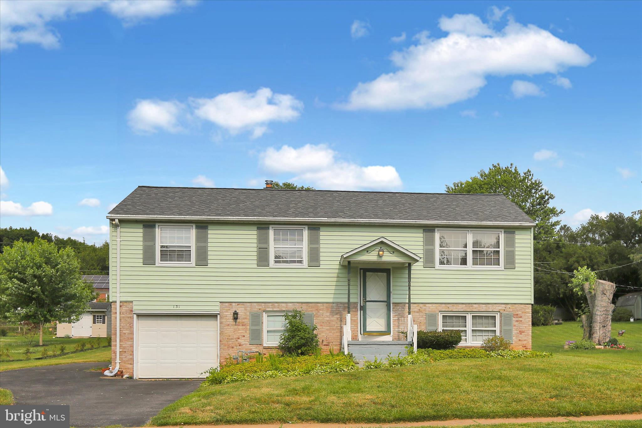 This bi-level home is filled with natural light and offers plenty of space to make your own. Enjoy the large sunroom, screened porch overlooking the spacious, flat backyard. There are three bedrooms with hardwood floors, while the lower level offers a fourth bedroom, a family room, a half bath, and a convenient mudroom with access through the attached garage.The roof was just installed. With a few simple cosmetic upgrades, this well-loved home presents an excellent opportunity to add your personal touch and build instant equity.