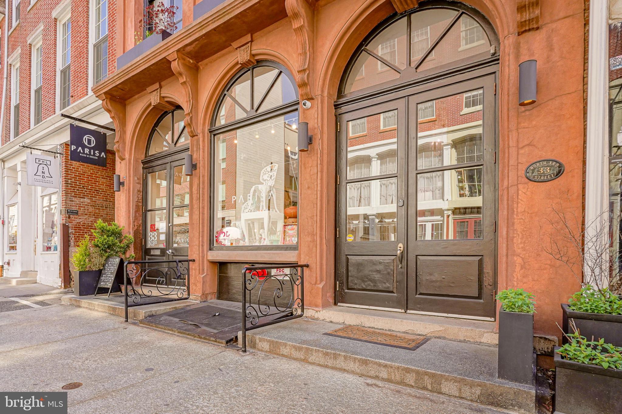 An art collector’s dream in the heart of Old City, the penthouse at 33 North 3rd Street offers a rare opportunity to own a true 19th-century warehouse reimagined for modern living at an extraordinary scale, complete with a private roof deck spanning over 1,400 square feet.

Originally constructed in 1853 and later used as a wool warehouse and leather tannery, the building’s industrial purpose is not just a detail, it is the defining feature of the home. The soaring ceilings, expansive walls, and dramatic proportions were built for storage and commerce, and today create a setting that feels purpose-built for a serious art collection or a buyer who values space, presence, and originality.

Spanning over 4,700 square feet across two levels, this two-bedroom, three-bath penthouse delivers a living experience that is almost impossible to replicate in Philadelphia. The scale is immediate and striking, anchored by a stunning glass atrium at the upper level that fills the home with natural light while thoughtfully preserving wall space below, an architectural feature that is as functional as it is visually dramatic.

The layout remains highly functional, with private elevator access via secure code to both floors, offering ease of living and flexibility for a range of lifestyles. The second level presents additional opportunities for customization, whether as expanded living space, workspace, or potential additional sleeping quarters.

What sets this home apart is its authenticity. Nothing here is artificial or forced. The architecture is real, the proportions are intentional, and the character has been earned over time. It is a space that carries a distinct energy, one that resonates immediately with the right buyer.

The primary suite offers a quieter, more refined counterpoint to the dramatic main living spaces, featuring a spacious walk-in closet, a well-appointed laundry area, and a spa-like bath complete with a steam shower. Along the main level, extensive built-in storage runs nearly the full length of the home, a rare and highly practical complement to the open loft design.

A true extension of the home, the private roof deck spans over 1,400 square feet and delivers sweeping 270-degree views of the Philadelphia skyline. It is a rare outdoor space of this scale, offering endless potential for entertaining, relaxing, or creating a one-of-a-kind urban retreat.

There is a true downtown loft sensibility throughout, reminiscent of New York’s most compelling conversions, yet with a level of square footage and value that is increasingly rare. Positioned at the top of a historic Old City building, the penthouse offers both presence and privacy, surrounded by some of Philadelphia’s best architecture, galleries, and restaurants. For added convenience, the seller is offering two years of two-car parking located directly adjacent to the building with an acceptable offer.

This is not a typical condominium, and it is not meant to be. For the buyer who has outgrown the expected and is searching for something with scale, soul, and lasting impact, this penthouse stands in a category of its own.