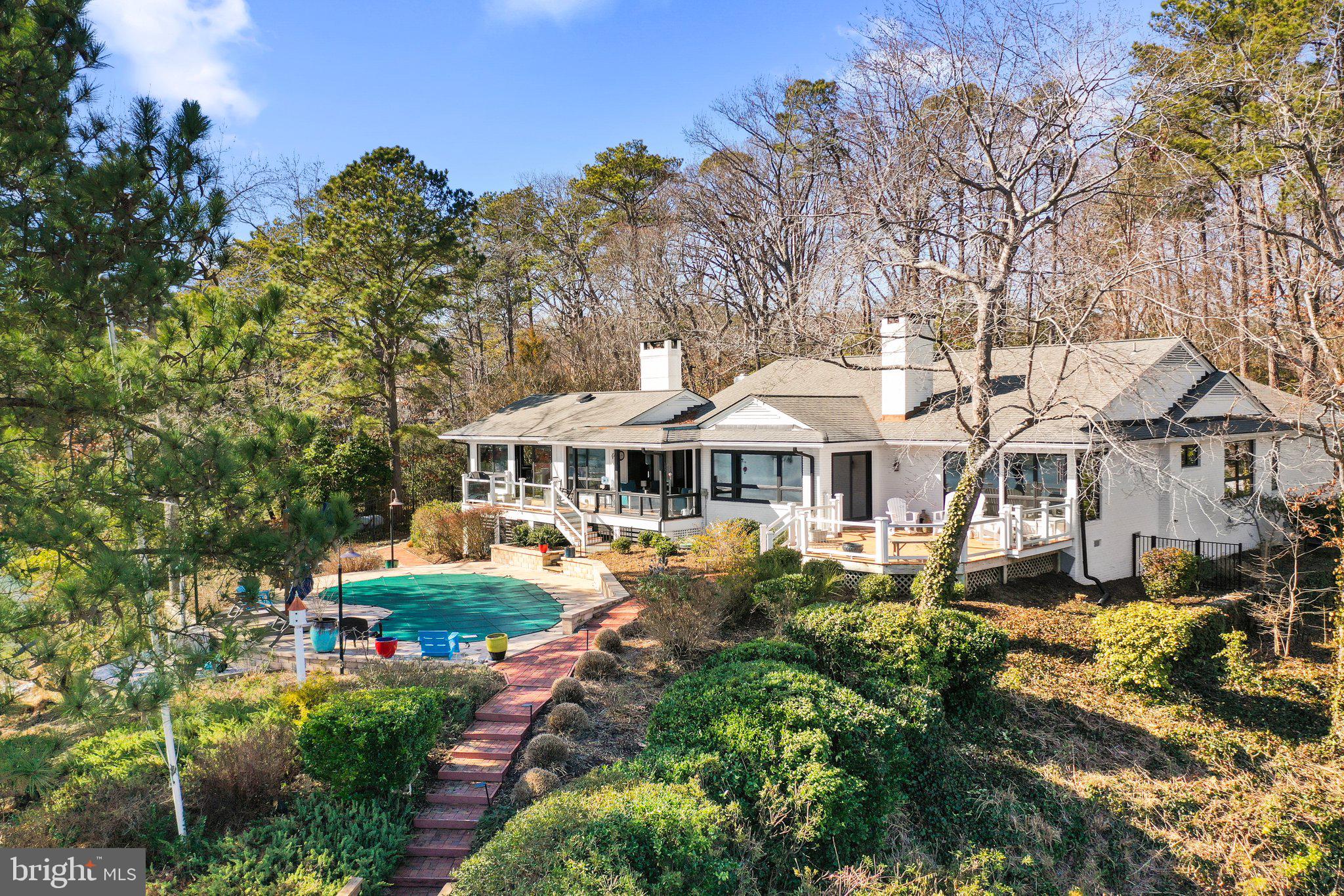 This stunning contemporary 3526 Sq. Ft. brick home, built in 1960 and completely renovated in 2022, was designed with rest, relaxation and joyful entertainment in mind, including a heated waterfront pool.  The light filled open floor plan offers gorgeous Carters Creek views throughout most of the house.  The heart of this magnificent home is the culinary kitchen, which opens to the dining area and gathering room, all facing the warming fireplace and offering expansive water views.  As you enter the large waterfront living room, you are immediately drawn to the beautiful custom designed walnut surround fireplace. If you are seeking a quiet place to relax,  the den offers tranquility with its two floor-to-ceiling wine coolers and overlooks the courtyard. The owners waterfront suite boasts lovely water views, a walk-in-closet, and a spa bath with heated floors.  There are three additional bedrooms, two full baths and a half bath. The two car garage is connected to the house via a covered breezeway. The landscaped yard, with its irrigation system and landscape lighting, requires little maintenance. The exterior also  features ample covered porches and decking that all step-down to the waterside pool. A gently pathway leads you to the deep water dock with four slips, a large floating dock, electricity and water, dock lights and boat lift. This is truly an exceptional home and site with amazing Carters Creek views, a deep protected harbor, and just a paddle board away from the Tides Inn and minutes to the quaint town of Irvington.  You must see this home in person to truly appreciate its thoughtful planning, quality materials and expert craftsman ship.