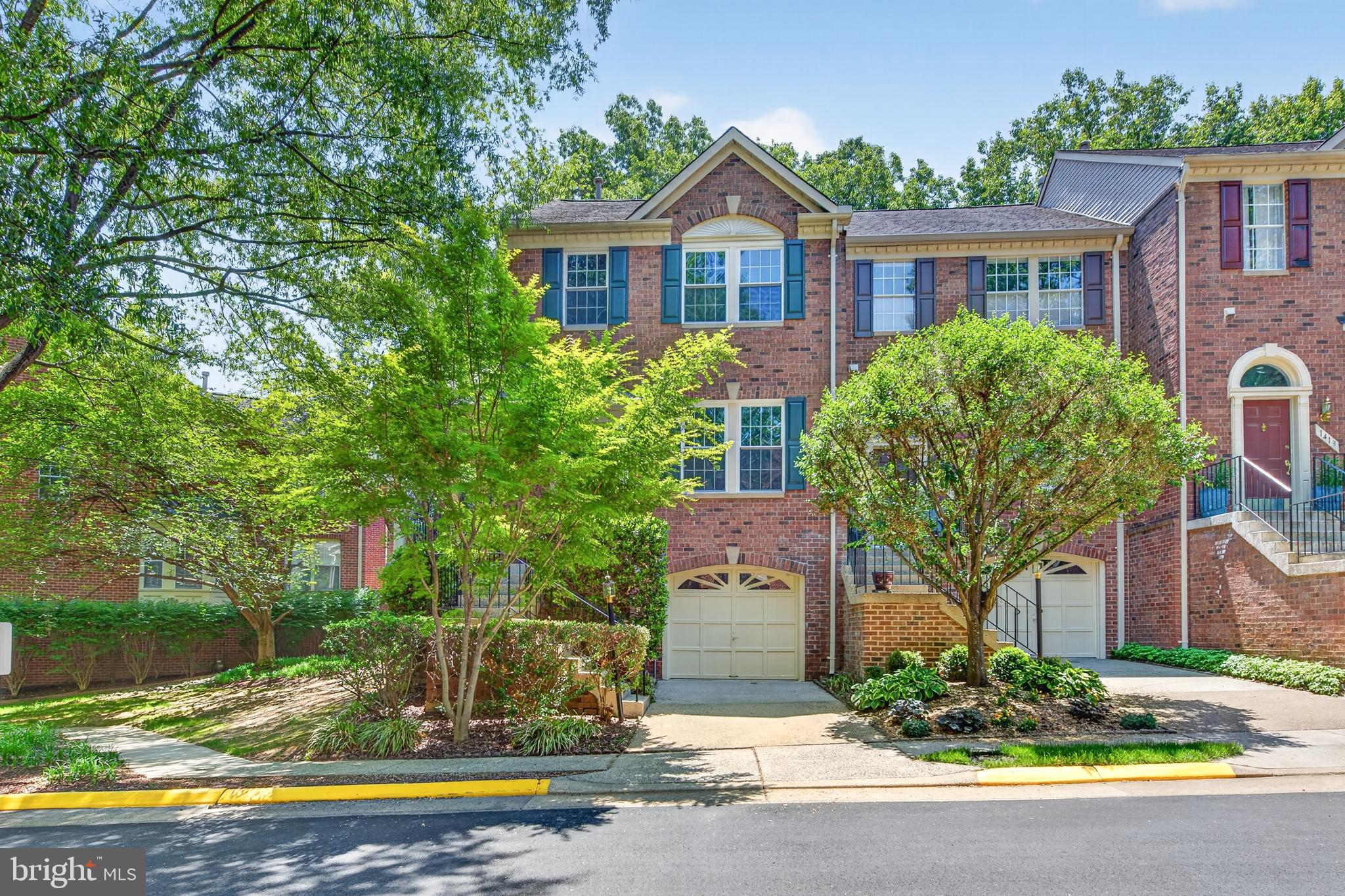 Located in desirable North Reston, this all-brick end-unit townhome offers a private setting backing to trees, along with access to Reston’s incredible amenities, including pools, tennis courts, trails, parks, and playgrounds. With a one-car garage, abundant guest parking nearby, and convenient access to shopping, dining, Reston Town Center, Metro access, and major commuting routes, the location is exceptional.

A charming wraparound front porch welcomes you into the home. Inside, the foyer features a convenient coat closet and opens to the spacious main level featuring luxury vinyl plank flooring throughout. The main level offers multiple living and gathering spaces, including a living room, dining room, family room, and breakfast area, along with a convenient powder room. The kitchen is equipped with granite countertops, a pantry, and opens to the breakfast room and family room. Just off the main level, the deck overlooks a peaceful, treed setting, providing a wonderful outdoor space to relax or dine outdoors.

Upstairs, all three bedrooms feature vaulted ceilings, adding to the open and airy feel. The spacious primary suite includes a large walk-in closet and an ensuite bath with tile flooring, a soaking tub, a separate shower, dual sinks, and updated faucets and light fixtures.

The lower level offers additional flexible living space with a recreation room, full bath, laundry room, and direct access to the one-car garage.

Enjoy the combination of privacy, functional living space, and an unbeatable North Reston location close to everything Reston has to offer.