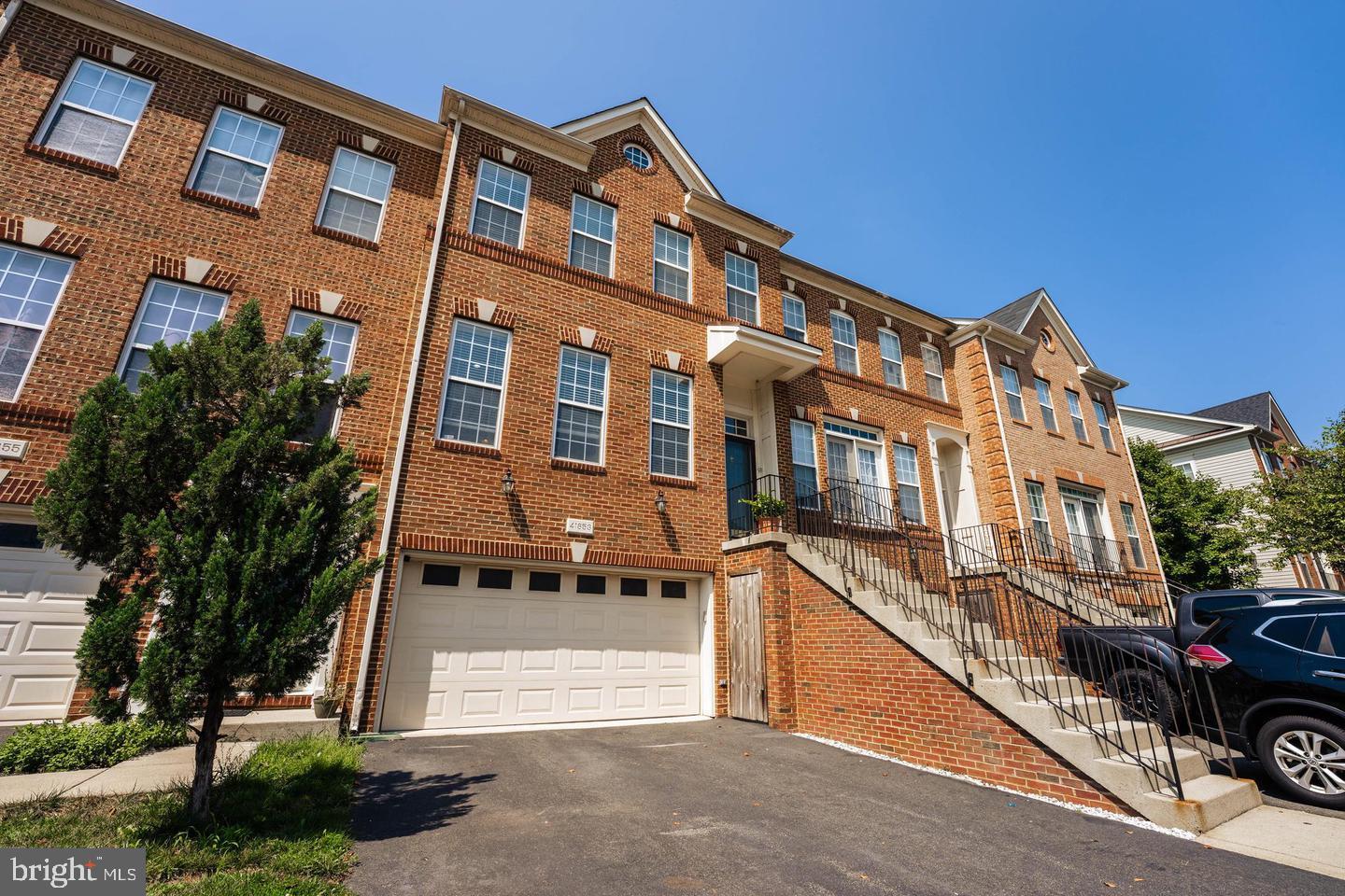 Welcome to this stunning, rarely available townhome in the heart of Stone Ridge! Thoughtfully extended across all three levels, this exceptional home offers 4 bedrooms, 3 full bathrooms, 1 half bathroom, and a 2-car garage — with the space, style, and finishes today's buyers are looking for.

The main level is made for both everyday living and effortless entertaining. A sun-drenched living room flows seamlessly into a formal dining area, leading into a beautifully renovated gourmet kitchen. The adjacent family room features rich hardwood flooring and opens to a charming sunroom — perfect for morning coffee — and a private deck backing to trees, ideal for outdoor dining and relaxing in nature.

Upstairs, the spacious owner's suite is a true retreat, complete with two walk-in closets, a generous sitting room, and a spa-inspired en suite bath featuring dual sinks, a soaking tub, and a frameless glass shower. Two additional bedrooms and a full bathroom complete the upper level.

The finished walkout lower level offers incredible versatility with a large recreation room, fireplace, a private bedroom, and full bathroom — all with its own separate entrance.

**Paint/touch-ups being made when tenant vacates July 8, 2026.

Beyond the front door, Stone Ridge living awaits: over 5 miles of scenic trails, two swimming pools, tennis and basketball courts, and beautiful Byrne Ridge County Park. Everyday conveniences — Harris Teeter, Costco, Giant, restaurants, and more — are minutes away, with easy access to Dulles Airport and major commuter routes including Rt. 50, Rt. 28, and Rt. 66.

This one truly has it all. Welcome home!