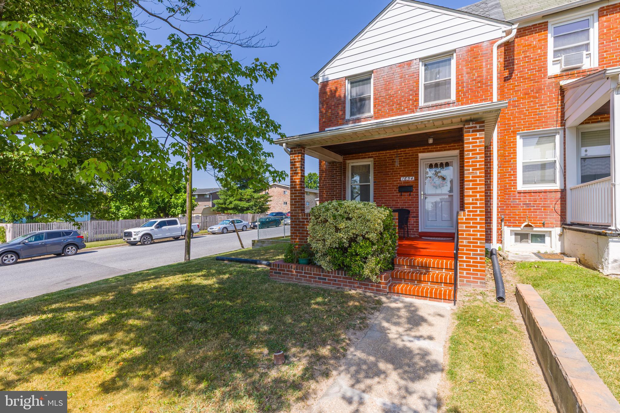 Welcome to 1654 Manor Road, a charming brick end-of-group townhome that offers the perfect combination of move-in-ready comfort, everyday convenience, and future potential. With nearly 1,500 square feet of finished living space, this home provides room to spread out while giving its next owner the opportunity to make it their own over time.

Step onto the covered front porch, the perfect place to enjoy your morning coffee, chat with neighbors, or unwind after a long day. Inside, you'll find a bright and inviting layout featuring three generously sized bedrooms and a full bath on the upper level. Beneath the existing carpet, you'll find original hardwood flooring waiting to be uncovered, offering the opportunity to restore timeless character and warmth throughout the main living areas and bedrooms. The finished lower level adds valuable flexible living space, complete with a half bath, making it ideal for a home office, workout room, playroom, guest space, or second living area.

Thoughtfully maintained, the home offers peace of mind with a roof replaced in 2019 and HVAC installed in 2013. While completely turnkey and ready for immediate occupancy, it also presents an exciting opportunity for future cosmetic updates, allowing the next owner to build equity while personalizing the space to their own style.

Outside, the end-of-group location provides additional privacy, extra natural light, and a larger yard than many neighboring homes. One of the standout features is the rare combination of off-street parking while still maintaining a functional backyard—offering the convenience of private parking without sacrificing valuable outdoor space for entertaining, gardening, pets, or simply enjoying time outside. The basement also features Bilco doors, providing direct exterior access that's ideal for storage, moving larger items, home projects, and an added measure of convenience and peace of mind.

Situated in a well-established Dundalk community, you'll enjoy quick access to I-95, I-695, Merritt Boulevard, and North Point Boulevard, making commuting to downtown Baltimore, Tradepoint Atlantic, the Port of Baltimore, and surrounding employment centers simple and efficient. Shopping, dining, parks, schools, and everyday conveniences are all just minutes away.

Whether you're looking for a home that's ready to enjoy from day one or one that offers the opportunity to add your own style over time, 1654 Manor Road delivers comfort, functionality, and lasting value in a location that keeps you connected to everything.