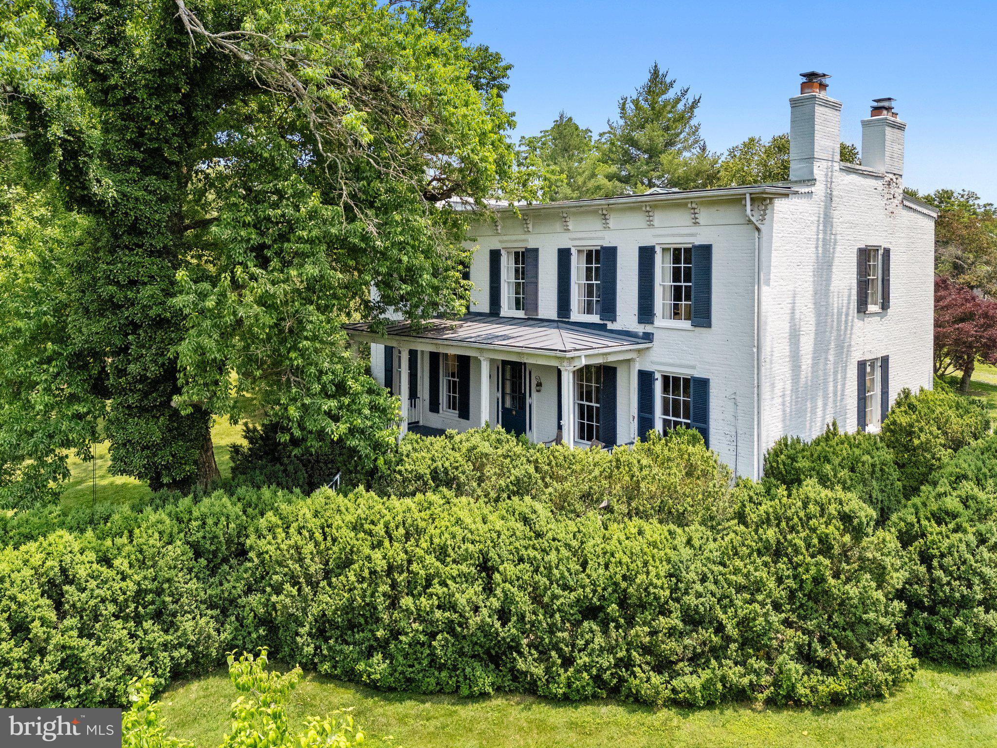 Hidden behind a privet hedge, adjacent to the village of Upperville, Alston House ( 1129 and 1131 Delaplane Grade Rd) offers privacy and gracious living on two level lots.  The main house was built in 1832 with an addition in 2002. It is approximately 6000 square feet on three levels, including 5 bedrooms and 4 1/2 baths.  The pool house across the lawn on the second lot was in built in 2006. It  is 3000+ square feet with a central great room which includes a kitchen and large pantry.   On either side are two bedroom wings each with separate bathrooms.  The pool house is used by the current owner as an art studio. The architectural integrity of the original historic house has been maintained while the 2002 addition accommodates more contemporary tastes.   Sited on 2+ acres, the grounds include extensive mature boxwood, beautiful gardens and landscaping and a  fishpond with a waterfall.  The property is fully fenced.  Alston House is a secret oasis of natural charm just outside the village of Upperville.   The current owner has completed many upgrades and updates.   See features list in the Document 
section.   Please note the property consists of 2 tax parcels
(6054-75-7394 & 6054-75-9340.)