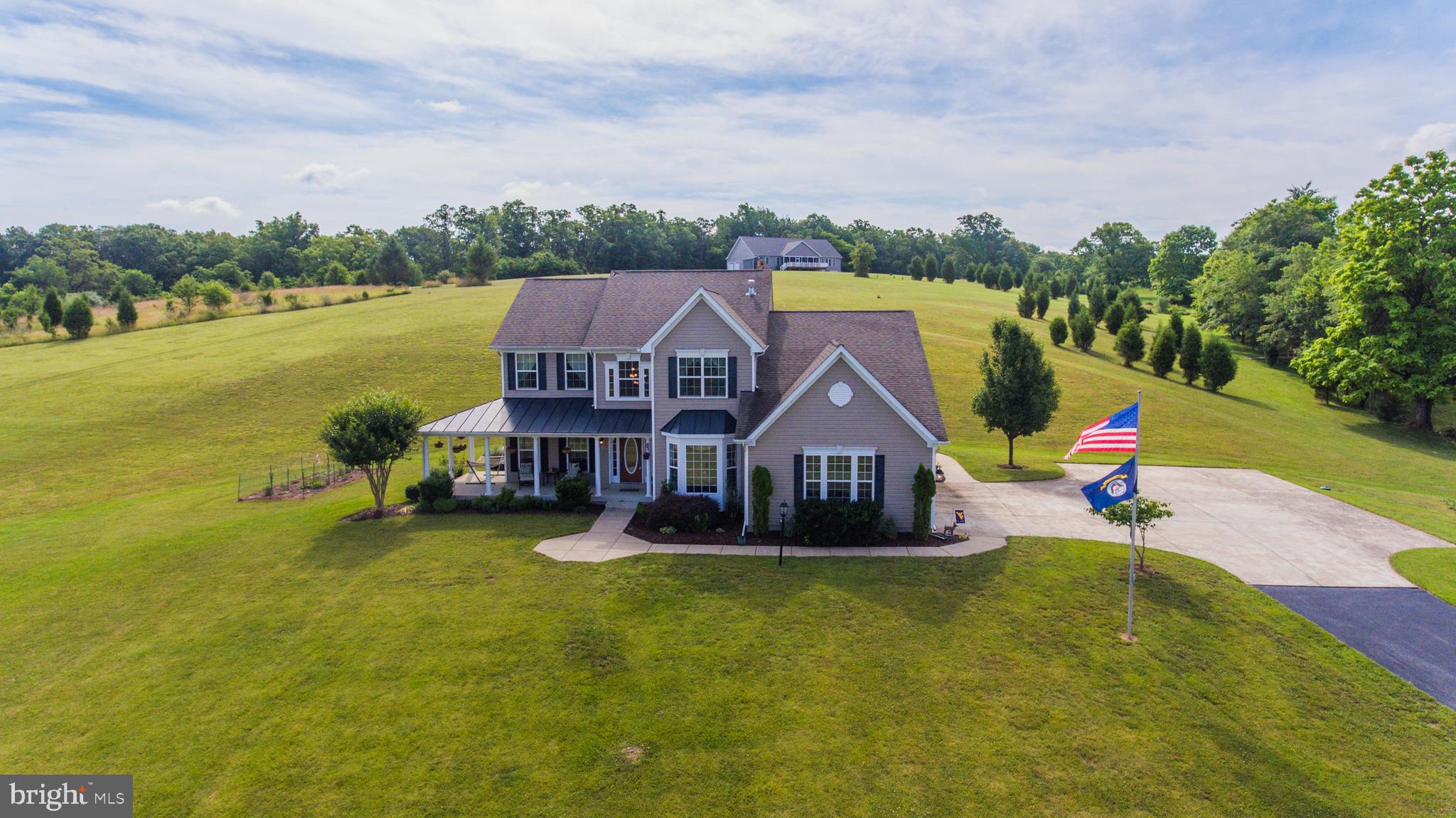 This amazing home has too many features to list. Everything you need is in this home. Custom built and one owner, very well maintained and YES you can have chickens!!! Beautiful hardwood flooring, two story foyer and family room, wonderful bedroom sizes, completely finished basement, 3 car side load garage and 5 acres of gorgeous land with vistas and privacy