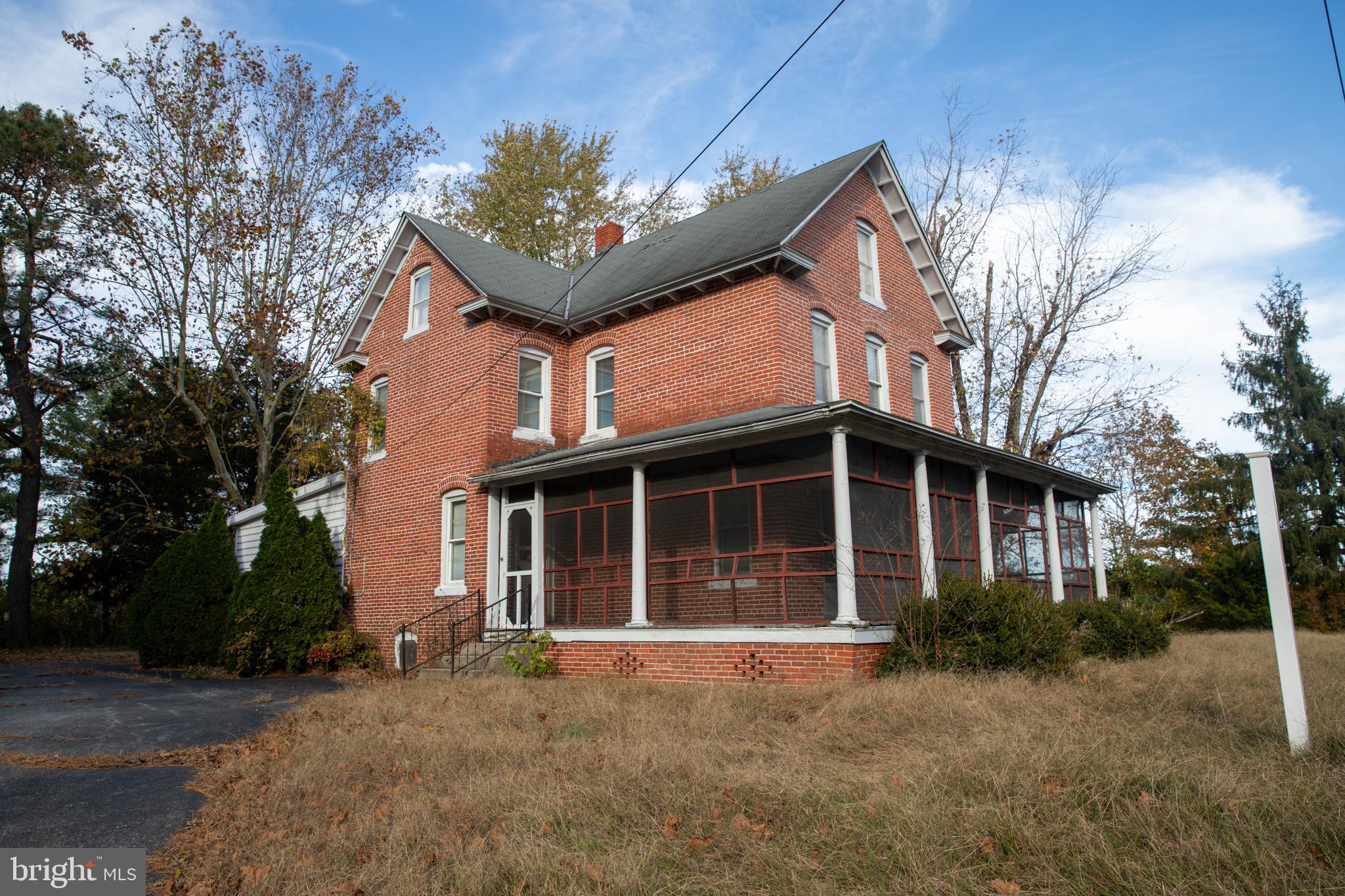 Welcome to 26121 Lewes Georgetown Hwy, a charming early-20th century farmhouse nestled on a generous 2-acre parcel in Broadkill Hundred, close to downtown Milton, Georgetown and the Delaware beaches. This property offers a unique opportunity to restore and customize a classic brick A-frame home built in 1936 – a character-filled canvass awaiting your vision.

The main house features approximately 2,800 sq ft of above-grade living space, including four bedrooms and two full baths. Inside you’ll find many original architectural elements – solid brick construction, vintage doors and hardware, exposed beams and large windows with storm & screen features – that evoke “this old house” charm and authenticity. While the home needs thoughtful updating, it presents an ideal restoration project for someone who appreciates historic character and wants to add value.

Outside, the expansive grounds include two sheds/out-buildings that lend flexibility for hobbies or workspace. Ample driveway parking (six spaces) makes it easy to host guests or accommodate a home-based business. Its location along a high-visibility corridor – just off Route 9 between Georgetown and Lewes – offers excellent exposure and vehicle traffic (approximately 15,000 cars daily on Route 9) for someone considering live-work, small commercial use, conditional rezoning or home-business opportunities.

Enjoy the best of both worlds: a serene rural setting, yet just a short drive to shopping, dining and the beaches of Lewes and Rehoboth. With its flexible zoning (AR-1) and sizeable footprint, this property invites creative possibilities – from full residential living to mixed-use or entrepreneurial ventures.

Sold AS-IS, this is your chance to breathe new life into a storied farmhouse with rich potential. Whether you want to restore a historic gem, launch a boutique business, or simply settle into coastal-Delaware living with easy access to recreation and amenities, this home delivers.