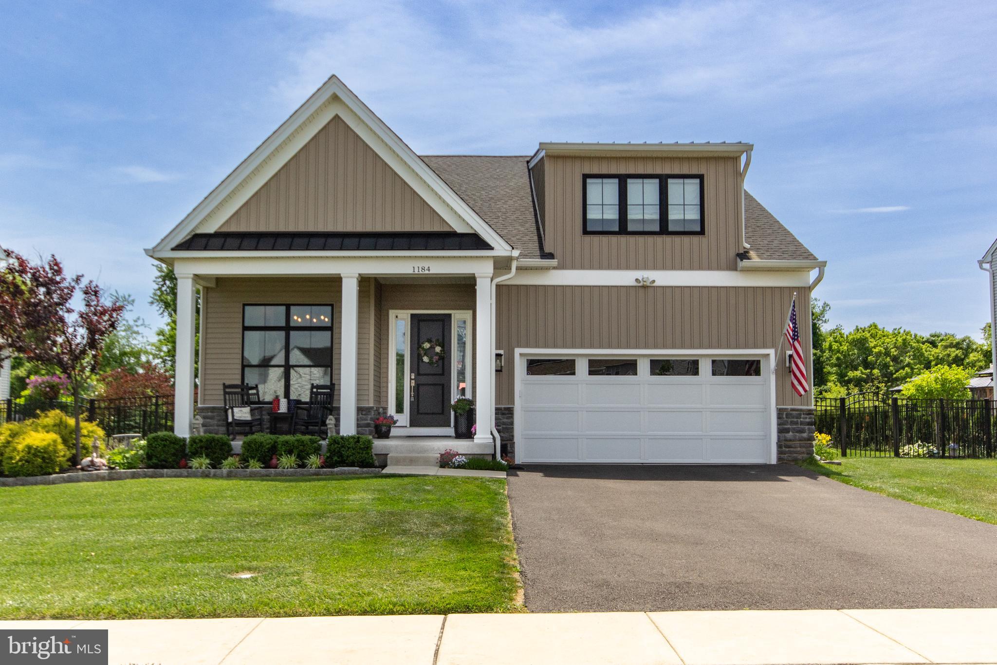 Welcome to one of Bucks County's most desirable luxury communities, Dautcher Farms.  1184 Harper Drive, is the only model in the neighborhood featuring a sought-after first-floor primary suite, offering the convenience of elegant one-level living. Ideal for multi-generational families

Originally built in 2001 with more than $150,000 in premium builder upgrades, the home has since undergone extensive enhancements, including over $120,000 in recent improvements and a beautifully finished lower level.

Step inside and be greeted by soaring 10-foot ceilings and an inviting layout designed for both comfort and sophistication. Just off the foyer, a charming room with a fireplace offers endless possibilities as a home office, library, sitting room, or intimate gathering space.

The thoughtfully designed floor plan leads to a newly renovated laundry room featuring custom cabinetry, granite countertops, and tile flooring. Beyond, the heart of the home awaits: a chef-inspired kitchen and spacious family room that seamlessly blend style and functionality. Entertain with ease while preparing meals in a kitchen enhanced by a custom coffee bar, upgraded pantry, and new Kitchen-Aid dishwasher.

The luxurious first-floor primary suite serves as a private retreat, complete with custom closet systems and a spa-like bathroom featuring a stunning new glass barn-door shower enclosure.

Upstairs, you'll find two generously sized bedrooms, a full bath, and a versatile loft area ideal for a home office, media room, or relaxation space.

The fully finished lower level significantly expands the living space and includes a fourth bedroom, full bathroom, media/game room, fitness area, and office. Completed with permits and proper egress, this level offers exceptional flexibility for today's lifestyle needs.

Additional highlights include custom closets throughout, a newly resurfaced garage floor, and a Tesla charging station.

Outside, the home truly shines. Situated on a premium lot backing to tranquil woods, the private, newly fenced backyard has been transformed into an outdoor oasis. Extensive landscaping, a spacious patio, and vibrant gardens create the perfect setting for entertaining, relaxing, and enjoying warm summer days surrounded by nature.

This is a rare opportunity to own one of the most upgraded and desirable homes in Dautcher Farms.