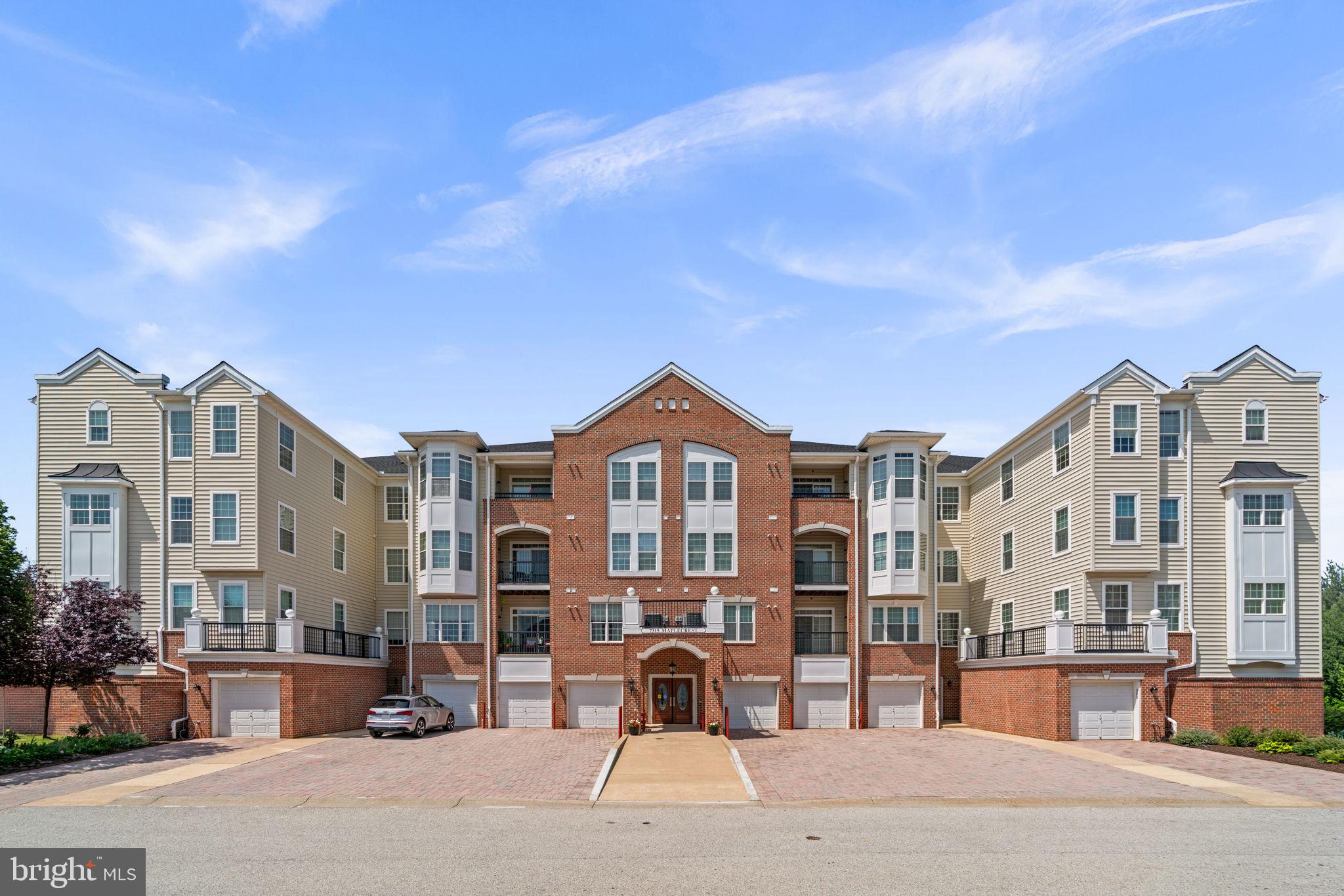 Beautifully maintained, freshly painted, and elevator-accessible condominium residence offering 2 bedrooms, 2 full bathrooms, and 1,500 finished square feet in the desirable 55+ community of Gatherings at Lyndwood. Designed for comfortable, low-maintenance living, this inviting home features an open-concept floor plan, abundant natural light, and recently installed carpeting throughout. // Step inside the welcoming foyer and into the well-appointed eat-in kitchen, featuring granite countertops, ample white cabinetry, stainless steel appliances recently installed in 2026, and a cozy breakfast area perfect for a bistro table. A convenient pass-through with breakfast bar seating seamlessly connects the kitchen to the main living area, creating a functional layout ideal for both everyday living and entertaining. Adjacent to the kitchen, a versatile den or formal dining room with hardwood flooring and a sparkling chandelier offers the perfect setting for a home office, library, or additional entertaining space. The spacious living and dining room is enhanced by a tray ceiling, plush carpeting, a ceiling fan, and a cozy gas fireplace, creating a warm and elegant gathering space. Sliding glass doors open to the covered patio, extending the living area outdoors. // The generously sized owner's suite offers a relaxing sitting area framed by elegant columns, dual closets including a walk-in closet, and a private ensuite bath with a dual-sink vanity. The secondary bedroom also features a walk-in closet and is conveniently located near the second full bathroom. A dedicated laundry room further enhances the home's comfort and functionality. // Enjoy peaceful wooded views from the covered walk-out patio, providing the perfect setting to relax and unwind. Additional highlights include a one-car garage (#104), an HVAC system replaced in 2023, and a building roof replaced in 2025. // Residents of Gatherings at Lyndwood enjoy an exceptional array of community amenities, including a clubhouse, outdoor pool, fitness center, tennis courts, and beautifully maintained common grounds, all just minutes from shopping, dining, and a nearby golf course. // Select photos have been virtually staged for illustrative purposes only.