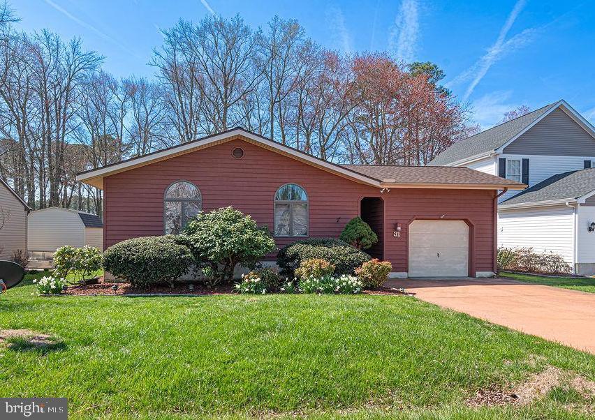 Located in the golf course section of Ocean Pines, 31 Watergreen Lane offers single-level living with a comfortable layout and an easy coastal feel. Vaulted ceilings with exposed beams and a wood stove add character to the main living space, while well-placed windows bring in natural light and keep everything feeling open. The kitchen offers a functional setup with breakfast bar seating, suited for both everyday use and casual gatherings. Just off the main living area, a screened porch and rear deck provide flexible outdoor space to relax or entertain. The home overlooks the fairway of hole 3 on the challenging Ocean Pines Golf Course,  and water views that add to the setting without sacrificing privacy. Major updates have already been completed, including the roof (2024), and water heater (2024), and a one-car garage adds additional storage and convenience. Ocean Pines offers a wide range of amenities, including several parks, five pools, miles of walking trails, indoor and outdoor pickleball courts, fishing ponds, a marina, and Yacht Club, all within a short drive to Berlin and the beaches of Ocean City. A solid option for full-time living or a weekend place near the coast.