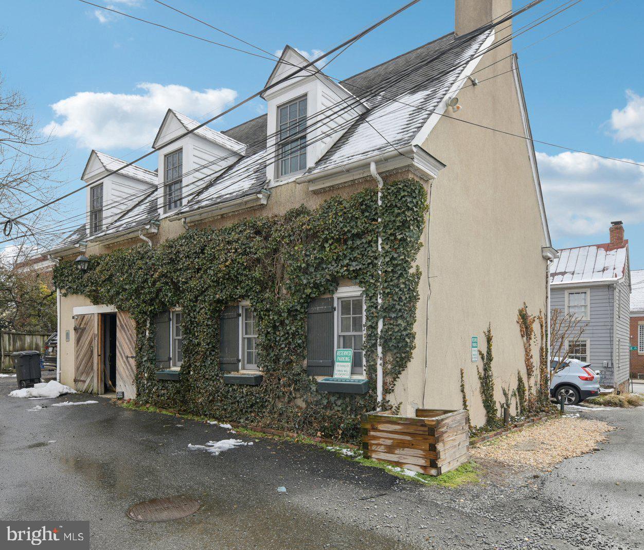 This is an exceptional opportunity to own a truly unique home and a rare piece of history. This beautifully renovated 19th-century carriage house offers 3 bedrooms and 2 full baths, blending historic character with modern convenience.  The main level features an open floor plan ideal for entertaining and everyday living, complemented by a beautifully remodeled kitchen and updated bath. Upstairs, you’ll find three bedrooms, a full bath, and a versatile multi-use family room. Several skylights flood the upper level with abundant natural light, creating a bright and inviting atmosphere throughout.  Perfectly tucked away on a quiet side street, you are just three blocks from the vibrant shops and restaurants of King Street and only a few blocks in the opposite direction from the King Street Metro.  Currently zoned CL (Commercial Low), this property offers outstanding flexibility and investment potential. The City of Alexandria’s CL zone is designed for low-intensity commercial, office, and service uses while serving as a transition to residential areas. Permitted uses include single-unit, two-unit, and multi-unit dwellings, townhouses, as well as small-scale office or personal service businesses. With two separate front entrances already in place, the home lends itself to creative possibilities — whether continuing as a single-family residence, converting to multiple units, or incorporating an approved business use.  A rare offering that combines historic charm, prime location, and exceptional versatility.  Assumable VA loan. Loan balance approximately $657,000. Interest rate 3.375%. The seller is willing to allow a qualified veteran to assume the existing loan in order to have the VA entitlement reinstated.