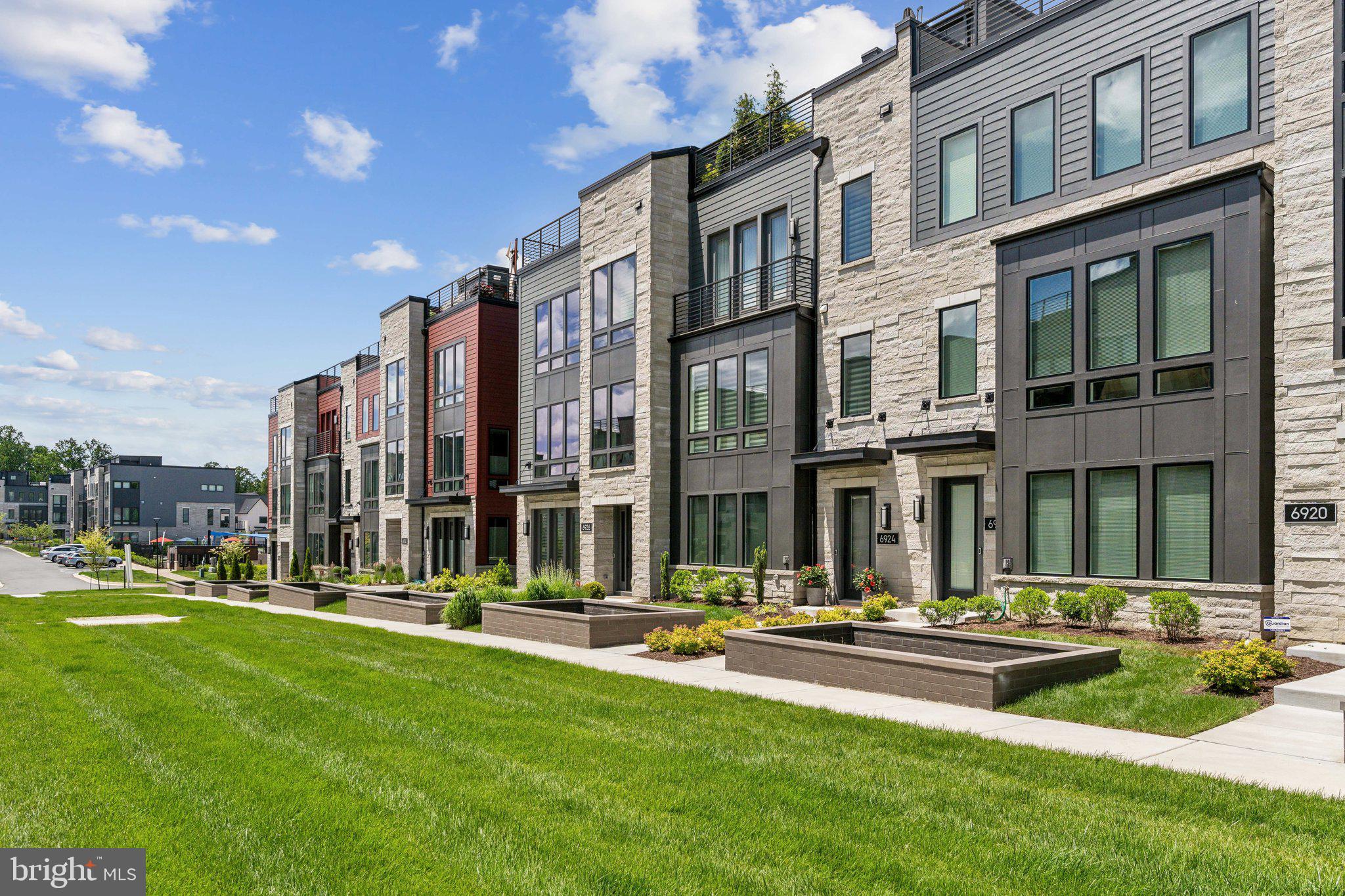 Welcome to the only townhouse currently available in Amalyn! Better than new 3-level Camelia model townhouse with ELEVATOR and roof deck. Open concept “On the Green” home, upgraded and customized throughout. 3/4 bedrooms, 3.5 baths. Every top-of the line option was chosen when built, including hardwoods throughout, upgraded kitchen cabinets and appliances, gas fireplace in living room, state of the art smart home technology, full bath on entry level, high-end tiled bathrooms, plumbing fixtures, and shower doors. Spacious tiled balcony off the main level is perfect for BBQ’s. Tiled roof deck provides further generous outdoor living space.  Custom designer finishes include porcelain wall and woodwork in entry level media room/office/possible 4th bedroom, living room Porcelanosa tiled fireplace wall with built-in’s, imported lighting fixtures in stairway hall, dining room, kitchen, and powder room. Every closet has been customized. Power window treatments in living room, powder room, and primary bedroom. Dressing table added in family bath. No detail left undone. Amalyn is a popular new Bethesda community with walking trails and nature paths, park, pool, kiddie splashpad, and fabulous clubhouse featuring  a gym, lounge, clubroom and bar.