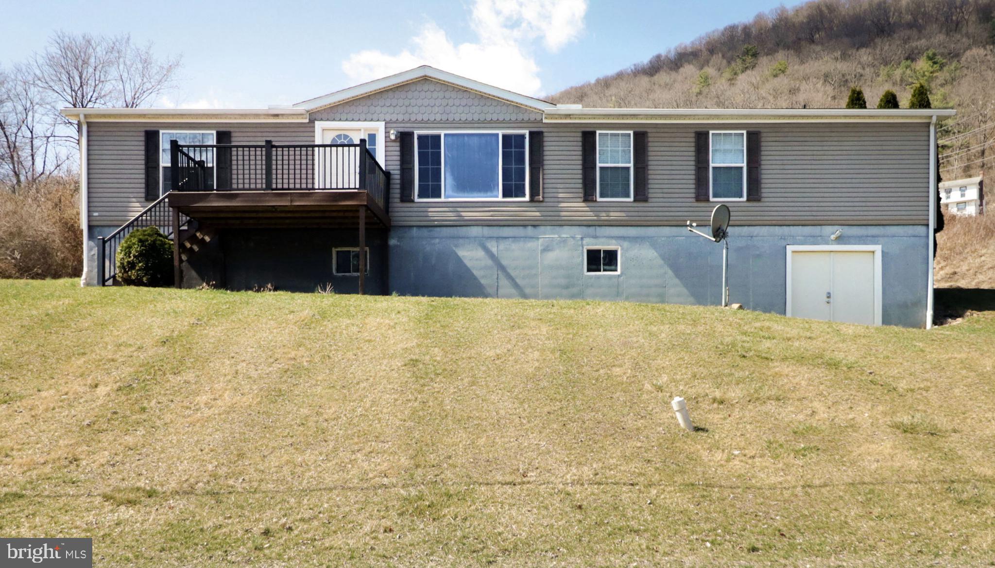 Perched on a scenic .46-acre hillside overlooking Spring Creek, this spacious turn-key manufactured home offers prime access to some of Pennsylvania’s premier fishing spots. Designed for seamless single-level living, it features an open & thoughtfully split floor plan, vaulted ceilings, new flooring & carpet throughout.  The light-filled living room welcomes you with a large picture window, while the spacious, updated kitchen boasts new luxury vinyl plank flooring, ample cabinetry, generous countertop space, delightful breakfast bar & included stainless appliances, perfect for those who love to cook & entertain. There is darling dining area with French doors & a relaxed family room with a cozy wood burning fireplace & built-ins add to the home’s inviting appeal.  The privately situated primary suite offers a true retreat with a spacious walk-in closet & a relaxing full bath featuring a corner soaking tub, walk-in shower & dual vanity. On the opposite end of the home, you’ll find 2 additional bedrooms & a full bathroom, ensuring privacy & comfort for family & guests.  The separate laundry room, with its own exterior entrance to the garage, is perfect for muddy paws or shoes. The full, unfinished walk-out basement provides abundant storage & exciting potential for future living space. Outside, you’ll appreciate the recently added oversized 2 car garage, large paved driveway & front Tyvek deck where you can take in all the beautiful views of neighboring mountain ranges. Additional amenities include a heat pump & refreshing central air conditioning.  Tucked away in a quiet yet convenient location, this home is just moments from downtown Bellefonte, where you’ll discover unique local shops, one-of-a-kind gift shops & a variety of charming restaurants that cater to both visitors & locals alike. Plus, with easy access to I-99, commuting to Penn State University is a breeze.  With its inviting layout, great updates & unbeatable location, this home is ready to welcome you home.
