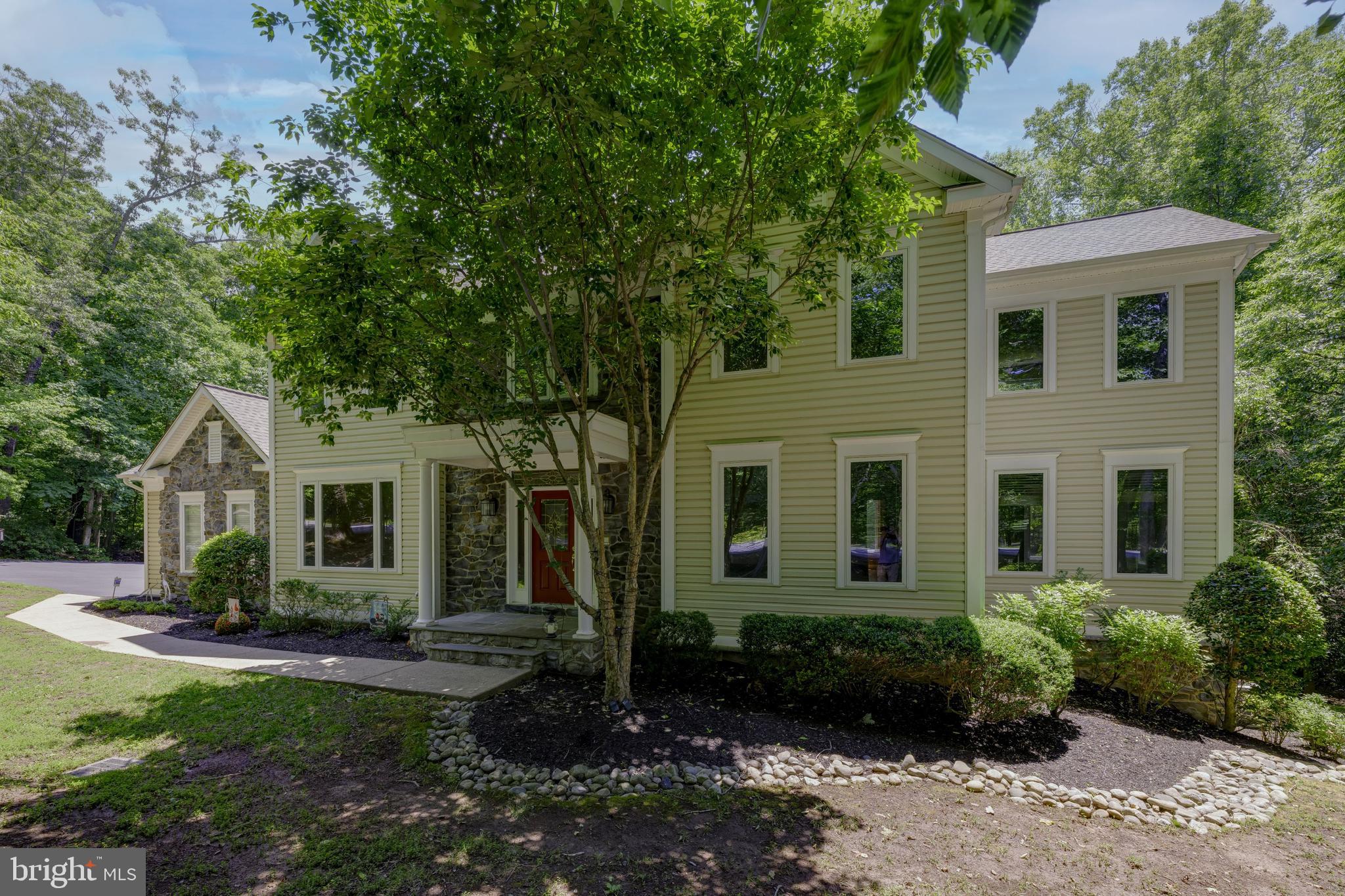 Without a doubt one of the nicest homes in the very desirable enclave of Occoquan Overlook...  This five bedroom custom  home by renowned local builder, Dave Dobbyn, is unique and shows pride of ownership in every detail.   From the stone exterior accents to the restaurant grade oven the upgrades and special features are almost too lengthy to mention.  You are welcomed to this estate quality residence by a very large foyer that hints at the very special features found throughout the home... gleaming hardwoods, double crown molding, high ceilings, and best of all, natural light flooding the space through a large transom.  Great room  measures 21 X 27 and has real stone fireplace, a butler's corner pantry with 68 bottle wine rack, both eyeball and recessed lighting and two skylights.  Double crown and finished-in-place hardwoods also continue in the dining room where there is a wonderful large picture window which looks out on specimen  trees and a manicured front lawn but it also has a Hunter Douglas venetian silhouette shade for privacy when dining in the evening.  Kitchen is a TRUE Chef's kitchen with a 6 burner Dacor oven.  It is fantastic!  Also top of the line Whirlpool fridge along with both wall oven and warming oven as well as an extra vegetable sink.  Kitchen has carefree engineered hardwoods and designer cabinetry featuring tons of storage and multiple glass doors to display fine wares on the upper shelves and is lit by numerous recessed lights.   Adjacent is a wonderful morning room with triple window plus sidelights overlooking the forested back portion of the property.    Main level also boasts a bedroom with full bath and magnificent year round sunroom... one of two sunrooms as there is also one en suite in the master sleeping chambers.  In addition to the master suite there are three more expansive bedrooms all with ample closet space.  There is also a thoughtfully located washer & dryer on the upper floor for a step saving lifestyle.   Lower level has entertainment area with second kitchen and bar,  private office, exercise room, large storage room .  As mentioned... the list is long... Recent HVAC, High end designer wood shades, The very best line of Berber carpets in bedrooms, Casablanca fans, Water treatment system, Upgraded vinyl tiles in sunrooms, Stereo speakers throughout, Leaded glass window accents, Main level guest suite, Granite counters, River rock backsplashes, Slate composite flooring, Trex decking, Dual zone HVAC, Home office, Exercise room... with equipment that conveys, Deck awning, Dog run... Even a room just for your dogs... including a dog shower... and a Dutch door to check on them if they are relegated to the room during guest visits!  Your living space is extended outside via a screened porch and oversized deck with automatic awning... Perfect for Al Fresco dining on Spring and Autumn evenings.  AND house is thoughtfully situated on sprawling parcel with mature trees and lush landscaping... The home is CITY CLOSE but COUNTRY QUIET as once you are home you never think you are SO close to the many newer restaurants, grocery stores and specialty shops along the Prince William Parkway, Old Bridge Road and Hoadly Road... Truly the best in Eastern Prince William County.  Maybe best of all just minutes to all major commuter routes and the VRE.  This is rare opportunity for your most discriminating buyer.  Show and sell today!