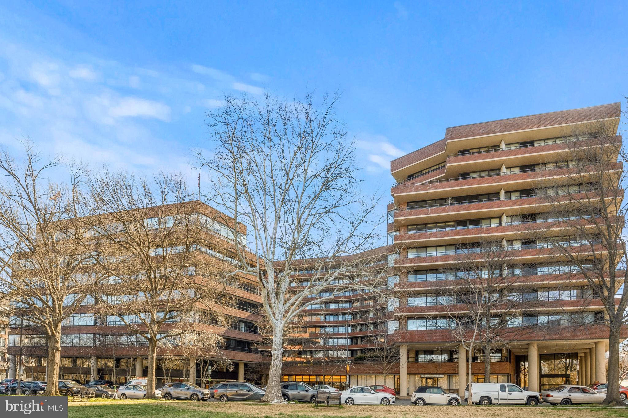 Nearly 1,400 square feet of well-proportioned living space with sweeping sunset views toward Georgetown and Rock Creek Park — visible from every room and framed by a 45-foot private balcony accessed through floor-to-ceiling sliding glass doors.
The open kitchen is anchored by a large center island with granite countertops, custom solid cherry cabinetry, and a premium appliance suite including Sub-Zero refrigeration and Bosch double ovens. A custom built-in bookcase with integrated cabinetry anchors the living area, adding warmth and function in equal measure. New imported hardwood floors run throughout.
The primary suite offers a walk-in closet plus an additional closet and a well-appointed bath with double vanity, soaking tub, and separate shower. The second bedroom — equally flexible as a guest room or home office — also features a walk-in closet. In-unit washer/dryer, garage parking, and a private storage unit round out the package.
The Westbridge delivers full-service living: 24-hour concierge and security, on-site management, building engineer, and dedicated porters. A heated outdoor pool, newly updated fitness center, and recently refreshed common corridors complete the picture. Pet-friendly.
Positioned in the West End, steps from Georgetown, Rock Creek Park trails, Trader Joe's, the Foggy Bottom Metro, and some of the city's most acclaimed dining and hotels — with easy access to the World Bank and IMF.