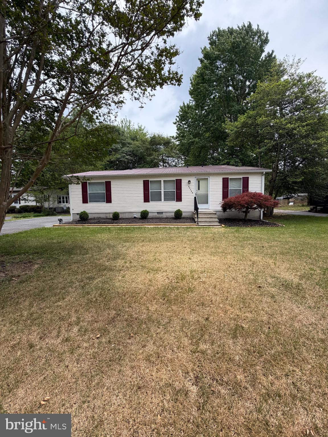 OWN YOUR OWN LAND.  Well maintained 1995 Double wide home with spacious recently updated addition offering unlimited opportunities, you could have an amazing great room, or create an office and maybe an additional bedroom, what ever you would need  or enjoy, there is plenty of room here.  The original Class C double wide features spacious living room Kitchen combo with eating area.  A split bedroom concept features the master bedroom with its own bath to one side, and the other two bedrooms with an additional bath on the other side.  Utility room with Washer and dryer,  small paver patio outside the sliding glass doors off the  Stick built addition.  Lovely back yard to use and enjoy.  Paved driveway, and landscaping.   The community HOA is only $400 for the year.  Water is community water and included in the $400.00 annual fee.   Great central location, convenient to Georgetown, Millsboro and not far to the beaches.