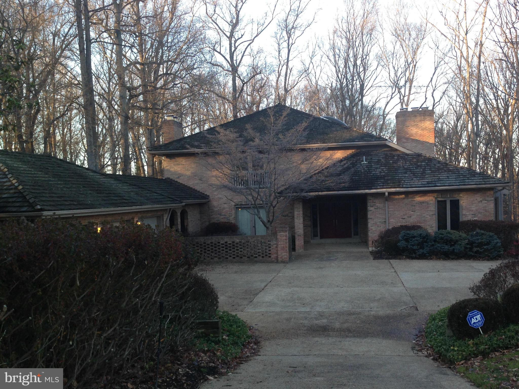 Spectacular Contemporary on gorgeous private acre lot. Large entry foyer. Spacious kitchen w/fireplace and huge center-island. Library with a wall of bookshelves. Screened porch.  Enormous master bedroom w/lots of closets & his & her bathrooms. Finished walk-out lower level w/huge recreation room plus two other rooms and two storage rooms. Three car garage. Original Condition. Needs updating.
