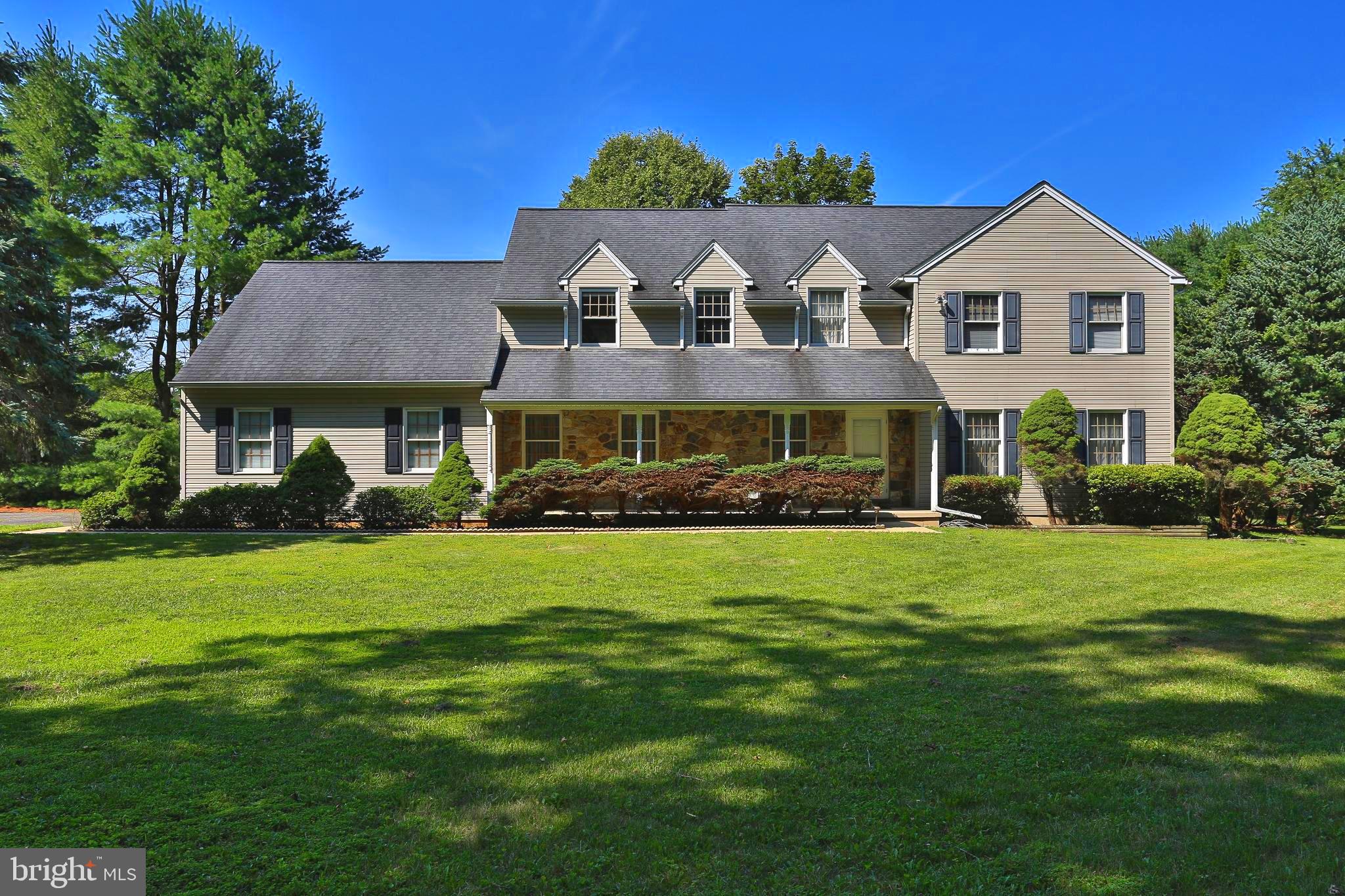 Beautifully maintained 4-bedroom, 2.5-bath Colonial nestled on 2.13 picturesque acres in the Quakertown School District. Surrounded by mature trees and lush landscaping, this exceptional property offers the perfect balance of privacy, space, and timeless curb appeal. A welcoming covered front porch leads to an impressive two-story foyer featuring soaring ceilings, abundant natural light, and an elegant oak staircase that creates a grand first impression. The thoughtfully designed floor plan offers an ideal blend of formal and casual living spaces, perfect for both everyday living and entertaining. The spacious formal living room is filled with natural light from oversized windows overlooking the beautifully landscaped grounds, while the formal dining room provides an elegant setting for holiday meals and special occasions. A classic chandelier, large windows, and seamless access to the kitchen make entertaining effortless. The heart of the home is the expansive eat-in kitchen, featuring abundant oak cabinetry, generous counter space, a double-bowl sink with backyard views, and a bright breakfast area surrounded by windows. The kitchen flows seamlessly into the inviting family room, where a stunning floor-to-ceiling stone gas fireplace creates a warm focal point. Sliding glass doors lead directly to the rear deck, extending your living space outdoors and providing the perfect setting for morning coffee, summer barbecues, or simply relaxing while enjoying the peaceful backyard views. Conveniently located just off the kitchen is a first-floor laundry room, adding everyday convenience and access to the impressive 3-car oversized garage, offering space for vehicles, tools, lawn equipment, or hobbies. Upstairs, the spacious primary suite offers a peaceful retreat with beautiful hardwood floors, oversized windows, and plenty of room for a king-size bedroom set. The private en-suite bath features a dual-sink vanity, walk-in shower, and a separate dressing area with an additional vanity. A large walk-in closet provides exceptional storage and organization. Three additional generously sized bedrooms, each with hardwood flooring, ample closet space, and large windows, offer comfortable accommodations for family, guests, or a home office. A well-appointed hall bathroom includes a double-sink vanity, abundant cabinet storage, and a tub/shower combination. The 48' x 30' unfinished basement presents endless possibilities for future living space, whether you envision a recreation room, home gym, theater, workshop, or additional entertaining area. bilco doors provide convenient walk-out access to the backyard, adding flexibility and functionality. Outside, you'll appreciate the expansive rear deck overlooking the private backyard, beautifully landscaped grounds. Additional features include a roof replaced in 2015, hot water heater installed in 2011, central vacuum system, and a generator hookup with a dedicated electrical connection, making it easy to connect a portable generator. Ideally located just minutes from major commuter routes, shopping, dining, parks, and everyday conveniences. This home offers the tranquility of country living without sacrificing accessibility. Combining spacious living areas, quality craftsmanship, thoughtful updates, and a beautiful natural setting, 2050 Miller Road is truly a special place to call home. Don't miss your opportunity to make this exceptional property your own.