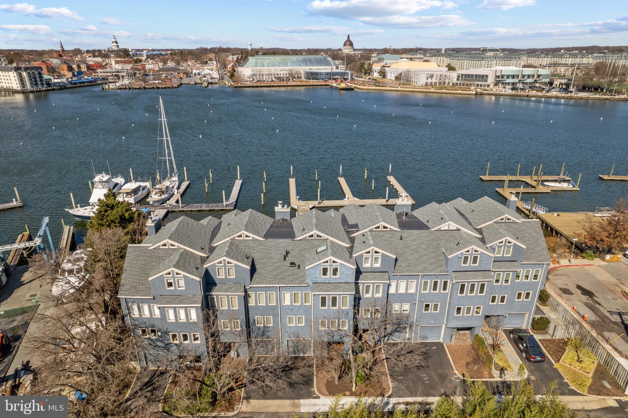 This exclusive waterfront townhome on Spa Creek/Annapolis Harbor offers what can be considered the best views in Eastport, offering unobstructed views of the Naval Academy, the city skyline, Capital Dome, the Yacht Club, and more across the Harbor, with the Severn River to the East. These views can be enjoyed from almost every room in the house, as well as from two private balconies, the teak deck and courtyard. Enjoy your 50" deep water slip (10 ft MLW) just steps from your back door. Inside you will find over 2800 sq ft of magnificently renovated, light filled space, complete with radiant heat wide plank oak flooring throughout, floor to ceiling transom windows, Waterworks hardware, custom lighting, power retractable blinds, built-ins, and much more. The designer kitchen offers honed marble counters, an expansive island, top of the line appliances including a La Cornue French range, abundant cabinet space, wine cooler, and built-in refrigeration drawers. The luxurious owners suite offers stunning water views, luxe bathroom, beautiful walk-in closet, and a private waterside balcony. The upper level family room is simply incredible, offering a Lepage retractable door system leading to a deck perched above the water for optimal views of the boat parade, fireworks, Blue Angel flyovers, and other Annapolis happenings. This level is completed by a gorgeous guest suite that can sleep a family of four. A one car garage is complimented by two additional driveway spaces, and there is guest parking in the private lot as well. This magnificent property offers turnkey luxury in one of Eastport's most desirable locations.
