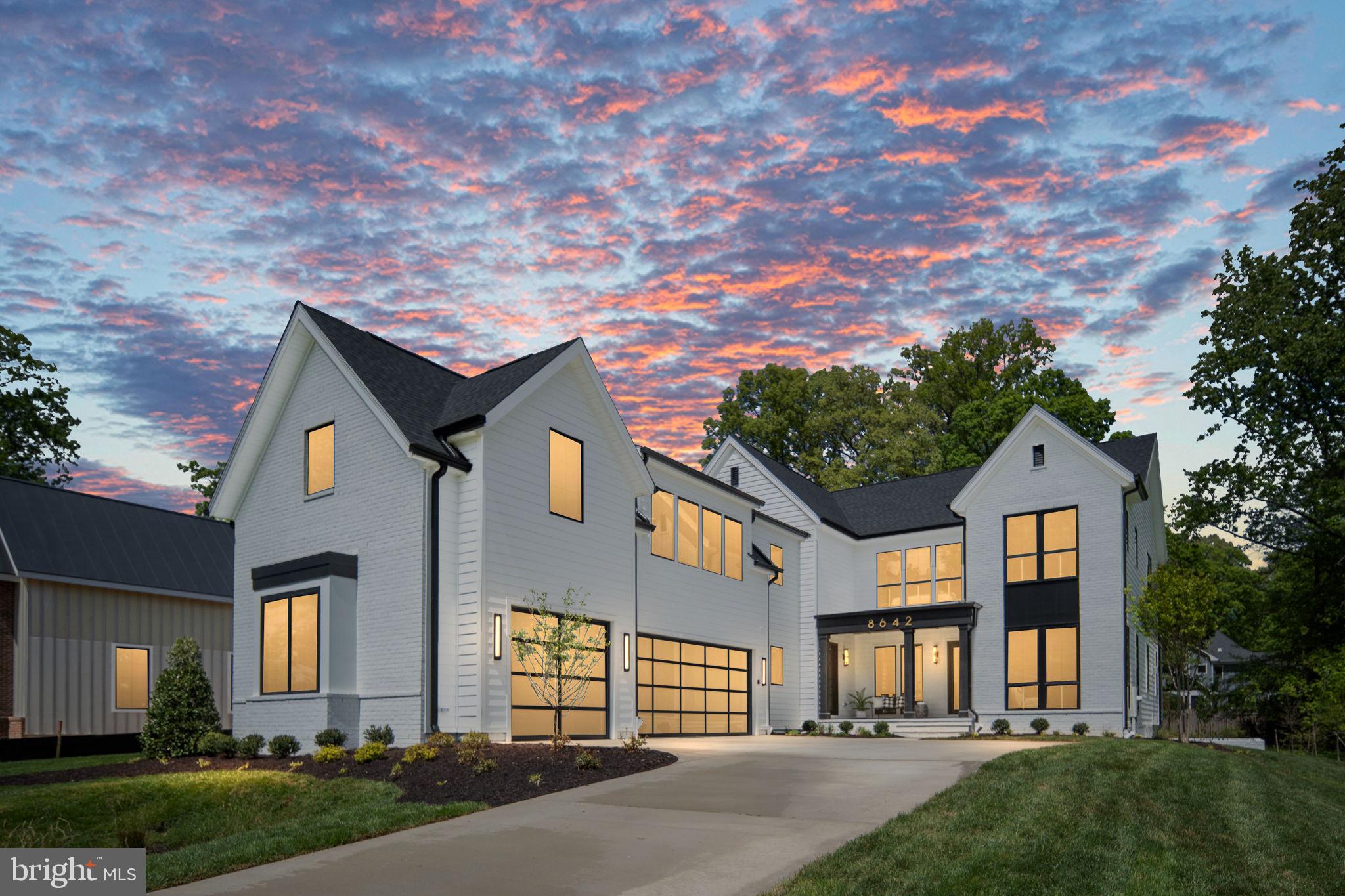 Capital Custom Homes proudly introduces 8642 McHenry Street, an extraordinary modern transitional residence set on a rare ½-acre homesite on one of Vienna’s most quaint and sought-after streets, complete with a highly coveted 3-car courtyard garage, full in-law/au pair suite,and back kitchen/pantry. Expertly crafted by Capital Custom Homes, this exceptional new construction offers over 7,300 gross square feet of meticulously designed luxury home, blending architectural sophistication with thoughtful functionality for today’s multigenerational lifestyle. Positioned on a quiet, established street known for its charm and sense of community, this home delivers the privacy, scale, and presence luxury buyers expect—just minutes from downtown Vienna. Our expansive Brooks floor plan features 7 bedrooms, 6 full baths, and 2 half baths, with soaring 10-foot ceilings on the main level and 9-foot ceilings above and below. Wide-plank white oak hardwood flooring flows throughout all three levels, creating a refined yet inviting aesthetic. Designed for elevated entertaining and seamless daily living, the kitchen is anchored by a chef’s Wolf/Sub Zero appliance suite, the gold standard in luxury performance. Highlights include a Wolf 48” Professional gas range, 48” built-in Sub-Zero refrigerator, Cove dishwasher, all complemented by full-overlay custom cabinetry stacked to the ceiling and heavy-profile quartz kitchen and island countertops that create substantial visual impact. A thoughtfully designed back kitchen/pantry and separate large servery with beverage center enhance entertaining flow while maintaining a pristine main space. A private main-level en-suite bedroom offers ideal flexibility as a guest suite or executive office. Upstairs, a thoughtfully designed in-law/au pair suite, separately accessible with back staircase or future elevator, provides rare independence and privacy—an exceptional feature for extended family or live-in support. The owner’s retreat serves as a true sanctuary, featuring hardwood flooring, dual quartz vanities, a soaking tub, and an oversized spa shower with rain and dual showerheads. Elevated Lower-Level Entertaining. The finished lower level is designed as a true extension of the home’s luxury lifestyle. The spacious recreation room features custom-built-ins and a dramatic floor-to-ceiling tiled fireplace, creating a striking focal point and refined gathering space. A thoughtfully designed wet bar enhances entertaining, making the lower level ideal for hosting guests or relaxing evenings at home. This level also includes a dedicated media room, exercise room with rubber flooring, full bath, powder room, and a generous seventh bedroom. An elevator-ready shaft provides future multi-level accessibility. Exceptional Outdoor Living Designed to maximize the beauty and scale of the ½-acre lot, the outdoor living spaces are equally impressive. An expansive screened porch functions as a three-season retreat, anchored by a stunning white brick 42” gas fireplace with wrought iron horizontal rails and a cathedral ceiling.  The porch flows seamlessly to an adjoining outdoor deck, offering generous space for dining, lounging, and entertaining while overlooking professionally landscaped grounds. This stunning backyard has ample space for a future pool or even a putting green! Exterior appointments include a rich brick façade, James Hardie Plank siding, architectural shingles, and a substantial slate front porch, steps, and walkway that reinforce the home’s timeless presence. Ideally located with convenient access to downtown Vienna, the shops and dining at Mosaic District and Tysons Corner Center, the Vienna/Fairfax–GMU Metro Station, and major commuter routes including I-66, Route 50,and Route 123. Photos and tour are of another model and may include optional upgrades. Contact the listing agent for pricing, specifications,and available customizations.