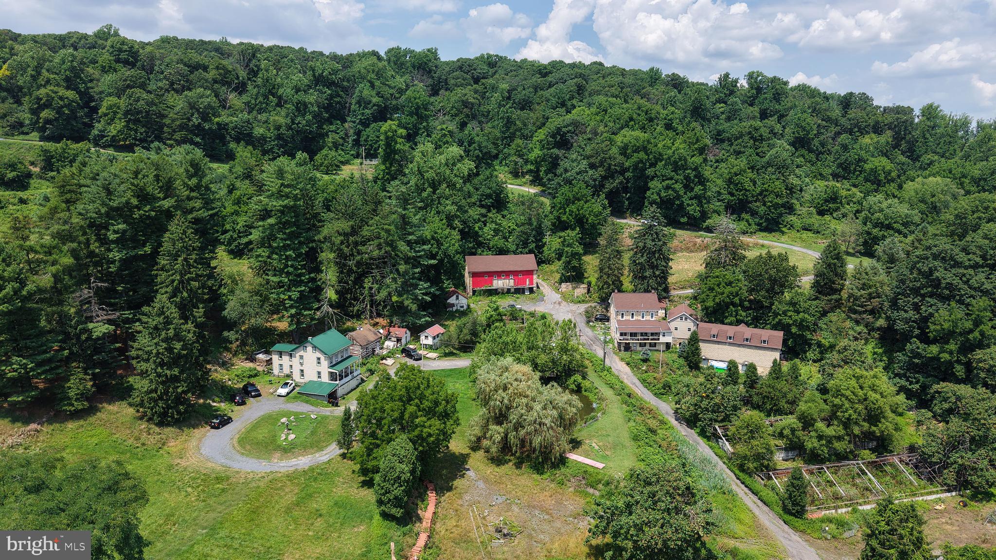 Welcome to a truly one-of-a-kind 10-acre property nestled in the heart of Lower Alsace Township. As you travel down the private lane, you'll be greeted by breathtaking valley views that set the stage for this secluded oasis—offering exceptional privacy while remaining just minutes from major highways, shopping, schools, and local amenities.

Rich in history and opportunity, this remarkable property has previously operated as a floral farm, vineyard, and wedding venue, and is currently enjoyed as a private family compound. With over 4,000 square feet of total living space spread across four separate homes, the possibilities are endless.

The property also features a barn, charming log cabin, greenhouse, outdoor kitchen, pond, multiple outbuildings and storage sheds, creating a setting that is as functional as it is picturesque. Numerous updates have been completed throughout the residences, including new flooring, fresh paint, updated electrical, and much of the work to separate the electrical service between the buildings has already been completed.

Supplied by its own natural spring, the property offers a unique blend of rural charm and self-sufficiency. Whether you're dreaming of creating a multigenerational retreat, operating an agricultural enterprise, establishing an event destination, or exploring another business opportunity, this extraordinary property provides a rare canvas for your vision. Buyers are responsible for verifying all intended uses with Lower Alsace Township.

Conveniently located approximately one hour from Philadelphia and within easy reach of Harrisburg, Lancaster, and the Lehigh Valley, this is a rare opportunity to own an exceptional property that combines privacy, beauty, versatility, and accessibility.