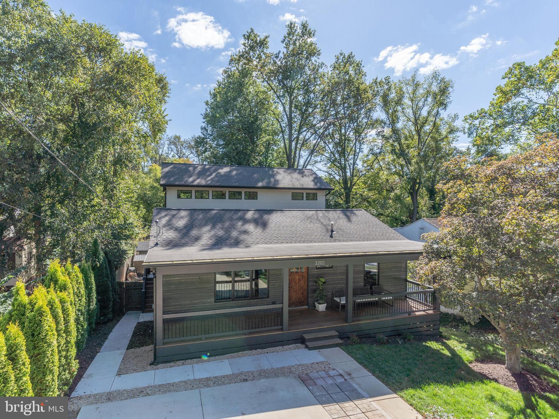 A reimagined and expanded Pearl Gold Certified green home designed for wellness, sustainability, and modern living.!

Symbi Homes does it again at 3202 Edgewood Road with another exceptional green renovation. Known for transforming homes into health-conscious, energy-efficient living spaces, this reimagined Mid-Century Modern blends thoughtful design, high-performance building, and flexible modern living.

The home offers 5 bedrooms, 3 bathrooms, and just under 3,300 square feet of finished living space, including a detached studio. The transformation thoughtfully blends preserved architectural elements with extensive modern upgrades, including a new roof, systems, appliances, and finishes throughout. Every space has been carefully redesigned to support beauty, functionality, and well-being.

From the moment you arrive, the home’s curb appeal makes a statement. Clean modern lines, a welcoming front porch, and the striking exterior of Energy Star aluminum-clad wood windows paired with TimberHue wood-look lap siding by James Hardie define its modern aesthetic. This home is only the second in the nation to feature durable TimberHue ahead of its Spring 2026 release, shown here in Weathered Oak for an authentic wood-inspired finish that complements the home’s Mid-Century character.

When you enter the home, you’re welcomed into a versatile front living space that can serve as a greeting area, dining room, or comfortable sitting room. From there, your eyes are immediately drawn to the striking three-level rear addition, where soaring ceilings and expansive windows flood the kitchen and family room with natural light, creating an open and airy atmosphere.

Anchored by a chef’s kitchen with a full island and bar seating, this space becomes the true heart of the home — ideal for both everyday living and entertaining. Just off the kitchen, step onto the spacious side balcony, offering a seamless extension of the indoor living area and a perfect place to enjoy morning coffee or evening gatherings.

This level also features 2 bedrooms and a full bath, along with a thoughtfully designed mud room that supports everyday organization and functionality.

Upstairs, the newly added primary suite isn’t just a bedroom — it’s a private retreat. The space features soaring ceilings highlighted by a beautiful exposed wood beam spanning across the room, along with a spa-like bath, a private balcony, a large walk-in closet, and a small attached bonus room that can be used as an office or cozy sitting area. It is truly your own personal haven.

The lower level, with its own entrance, includes 2  bedrooms, a full bath, kitchenette, recreation room, and laundry, creating an ideal space for guests, multigenerational living, or potential rental income.
A detached backyard studio adds even more flexibility, whether used as a gym, home office, or creative studio, all while offering privacy just steps from the main home.

This home showcases Symbi Homes’ signature approach to health and sustainability, featuring:

All-new high-efficiency heat pump HVAC and water heating,
PV-ready infrastructure for future solar and EV charging,
Upgraded smart electric panel with energy monitoring,
Beyond-code insulation and air sealing,
Green-certified, sustainable materials,
Intuitive smart home automation.

Nestled in the Homewood neighborhood of Kensington, a quiet, tree-lined community known for its walkability and charm, this home offers effortless access to parks, playgrounds, and the Saturday farmers market. Enjoy dinner at The Dish & Dram or a slice at Continental Pizza, along with other beloved local restaurants. The Kensington MARC Station is also within walking distance, offering an easy commute to Washington, D.C., and beyond.

This is more than a renovation — it’s a reimagined way to live.
