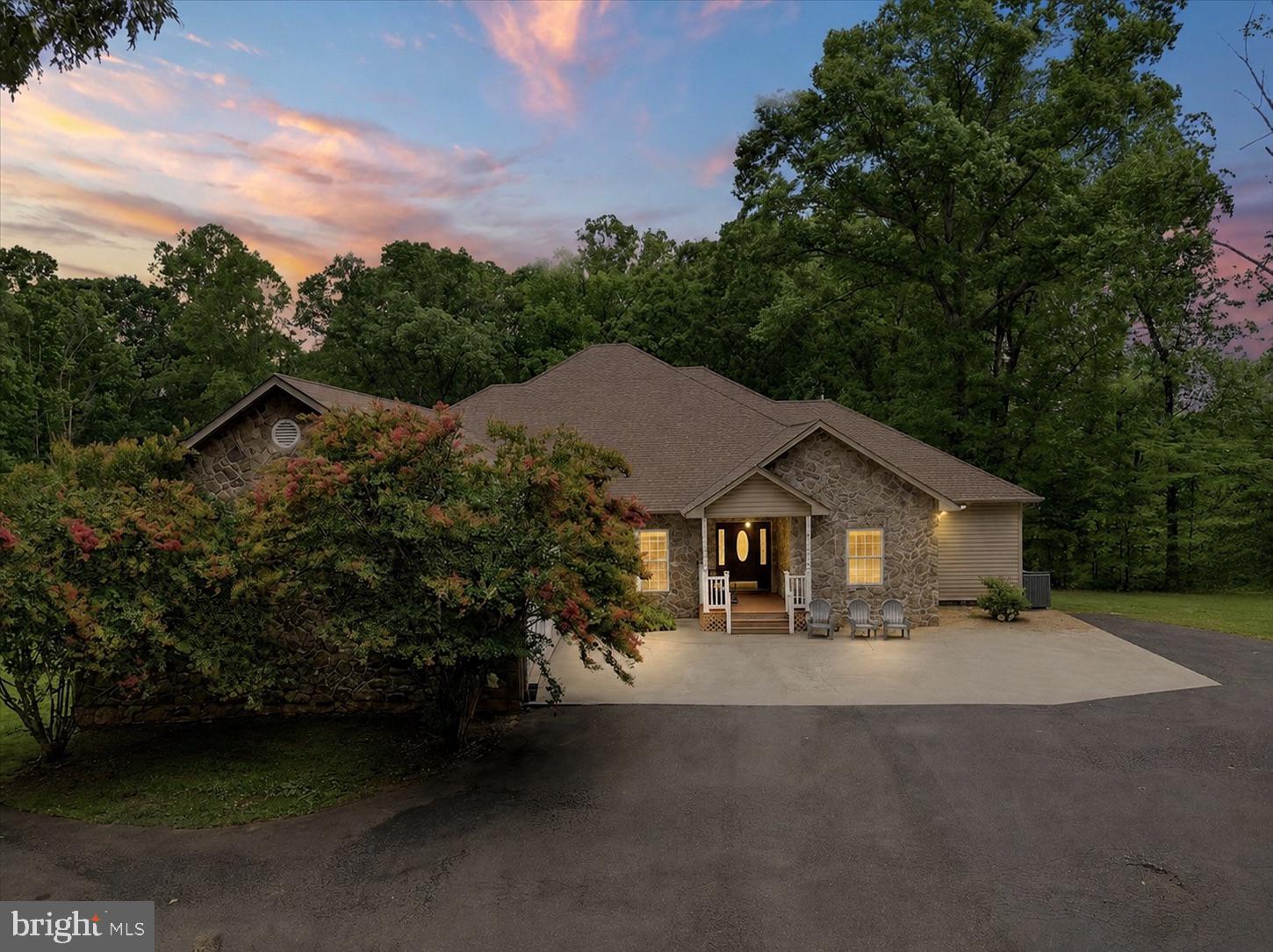 Welcome home to 520 Oak Grove Drive, one of the most spacious properties available at Lake Anna, now available with an incredible 4.7% assumable VA loan for qualified buyers! This is a significant savings compared to today's market rates and a rare opportunity at this price point and property size.
Situated on the public side and just minutes from Food Lion, Coyote Hole, the nursery, and Lake Anna's main shopping corridor, this home offers the rare combination of privacy and convenience.

This custom 6 bedroom, 4 bathroom home spans over 7,500 total sq ft, with 3,790 sq ft on the main level plus an approximately 2,248 sq ft finished walkout basement. A paved driveway and striking rock façade set the tone before you even step inside. A deeded boat slip is included.

Recently refreshed with a new stainless refrigerator and modern lighting fixtures throughout, the home feels move in ready. The main living area centers around a stone fireplace and flows into an expansive kitchen with granite countertops and abundant cabinetry, ideal for entertaining. Just off the living room, a covered walkout deck with tile flooring extends your living space outdoors.

The main level offers 5 generously sized bedrooms, a full laundry room, and direct access to the oversized 2 car garage. Downstairs, the finished basement adds a second living area, a spacious 6th bedroom perfect for multiple beds, and large windows overlooking the peaceful backyard.

Spread across 9.3 acres, there's room to roam, garden, or simply unwind. Lake Anna common area access is included, so bring your boat, paddleboards, and guests. A deeded boat slip, #9, comes with the property, giving you the kind of direct lake access that's increasingly hard to find at Lake Anna. This home has been successfully operated as a short term rental, and short term rentals are permitted, making it an excellent turnkey investment opportunity. It's just as well suited as a full time family residence or weekend retreat for those simply looking to enjoy everything Lake Anna has to offer.

Just 1 hour from Richmond, Fredericksburg, and Charlottesville, and 2 hours from D.C., properties of this size and location at Lake Anna rarely come available. Schedule your private showing today!