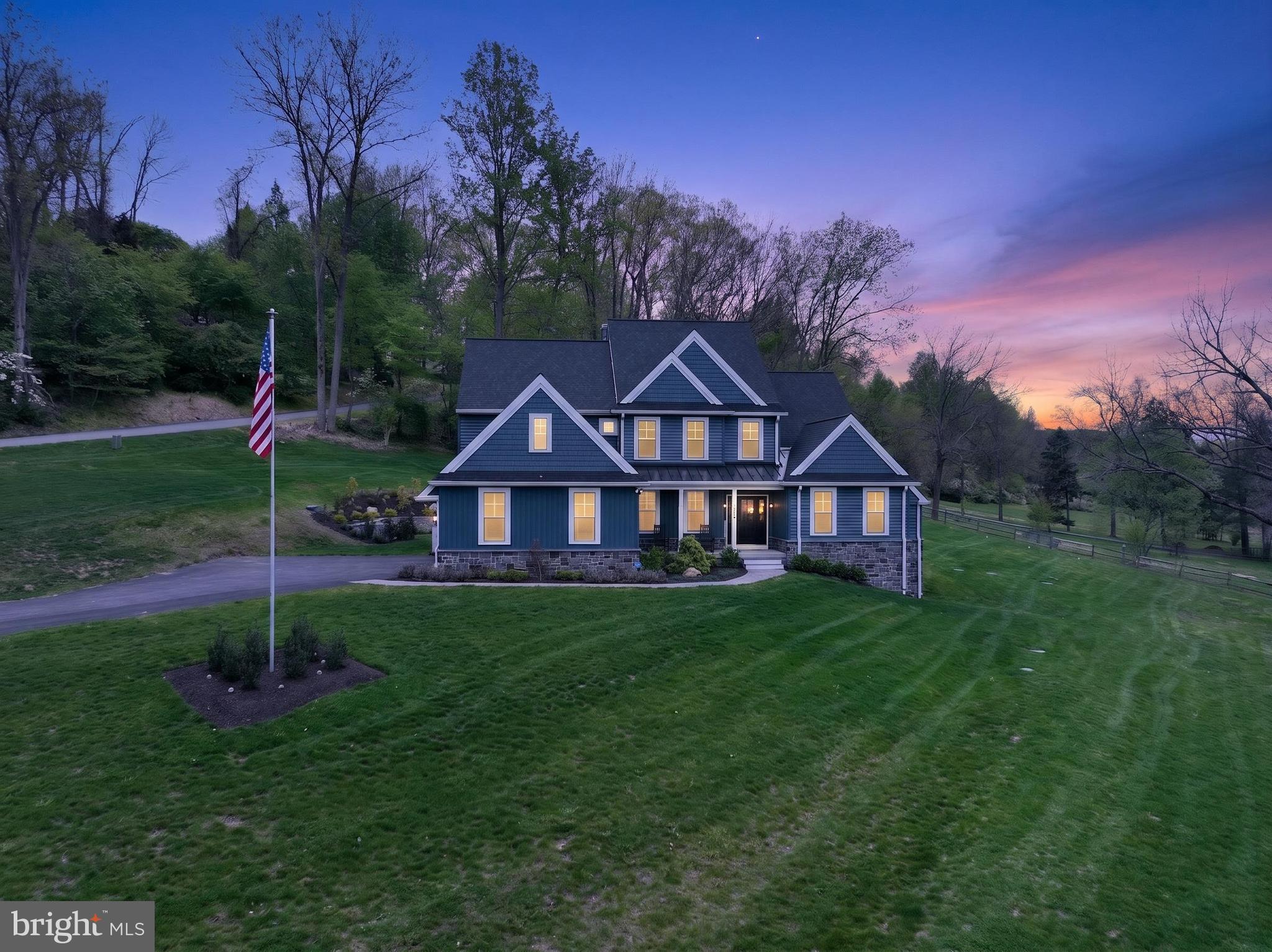 Set on almost 3 breathtaking acres in highly desirable Middletown Township, this exceptional custom-built home (built in 2023) offers the perfect blend of luxury, privacy, and timeless design. Perched gracefully atop a gentle hill, the property boasts stunning curb appeal and sweeping views of neighboring farms and serene ponds, creating a picturesque, estate-like setting.

The welcoming front porch is ideal for rocking chairs and quiet mornings. Inside, you’re greeted by a sun-drenched home office featuring expansive windows and generous closet storage, offering an inspiring work-from-home retreat. The formal dining room sits just off the entry, perfectly sized for hosting holidays and special gatherings.

The impressive two-story foyer flows seamlessly into a dramatic two-story family room, where large windows frame the scenic landscape and flood the space with natural light. A striking double-sided fireplace connects the family room to the heart of the home; the chef’s kitchen and breakfast area.

Designed for both everyday living and entertaining, the gourmet kitchen features GE Profile appliances, custom Century Kitchens cabinetry, a large center island, double ovens, and a statement hood vent. A stunning herringbone backsplash extends from the range to the ceiling, adding a sophisticated design element. Just beyond, doors lead to the patio and backyard, offering endless possibilities for outdoor living—with additional space to clear for even more usable land if desired.

Convenience meets functionality with a well-appointed mudroom and powder room located just off the kitchen, providing easy access to the three-car garage.

The first-floor primary suite is a true retreat, showcasing peaceful pond views, abundant natural light, a spacious custom-outfitted walk-in closet, and a luxurious en-suite bath with dual vanities and an oversized walk-in shower.

Upstairs, a thoughtfully designed layout includes a private “mini primary” suite with its own bath, two additional generously sized bedrooms connected by a Jack-and-Jill bathroom, and a versatile fifth room, ideal as a bedroom, playroom, or additional living space.

The walk-out basement offers incredible potential, already framed by natural light and scenic views, and ready to be finished to suit your vision whether it’s a home theater, gym, bar, or additional living quarters.

Additional highlights include luxury vinyl plank flooring throughout, a whole-house generator, a three-car garage with epoxy flooring, motorized window treatments, dimmable recessed lighting, a water softener system, and a full security system with cameras and remote access. A 12x20 shed sits on the other side of the driveway making it a convenient place to store lansdscaping tools, toys, etc. The roof and siding are both under transferable warranties, providing added peace of mind.

This is a rare opportunity to own a nearly new, thoughtfully designed luxury home in a truly idyllic setting, offering space, sophistication, and unmatched views. Other features include close proximity to all major routes (I-95, I-476, Rt 1), Walkable to Middletown's Trail System, Close to Ridley Creek State Park and a ton of parks/playgrounds. Located near Wawa & Elwyn SEPTA regional rail stations.