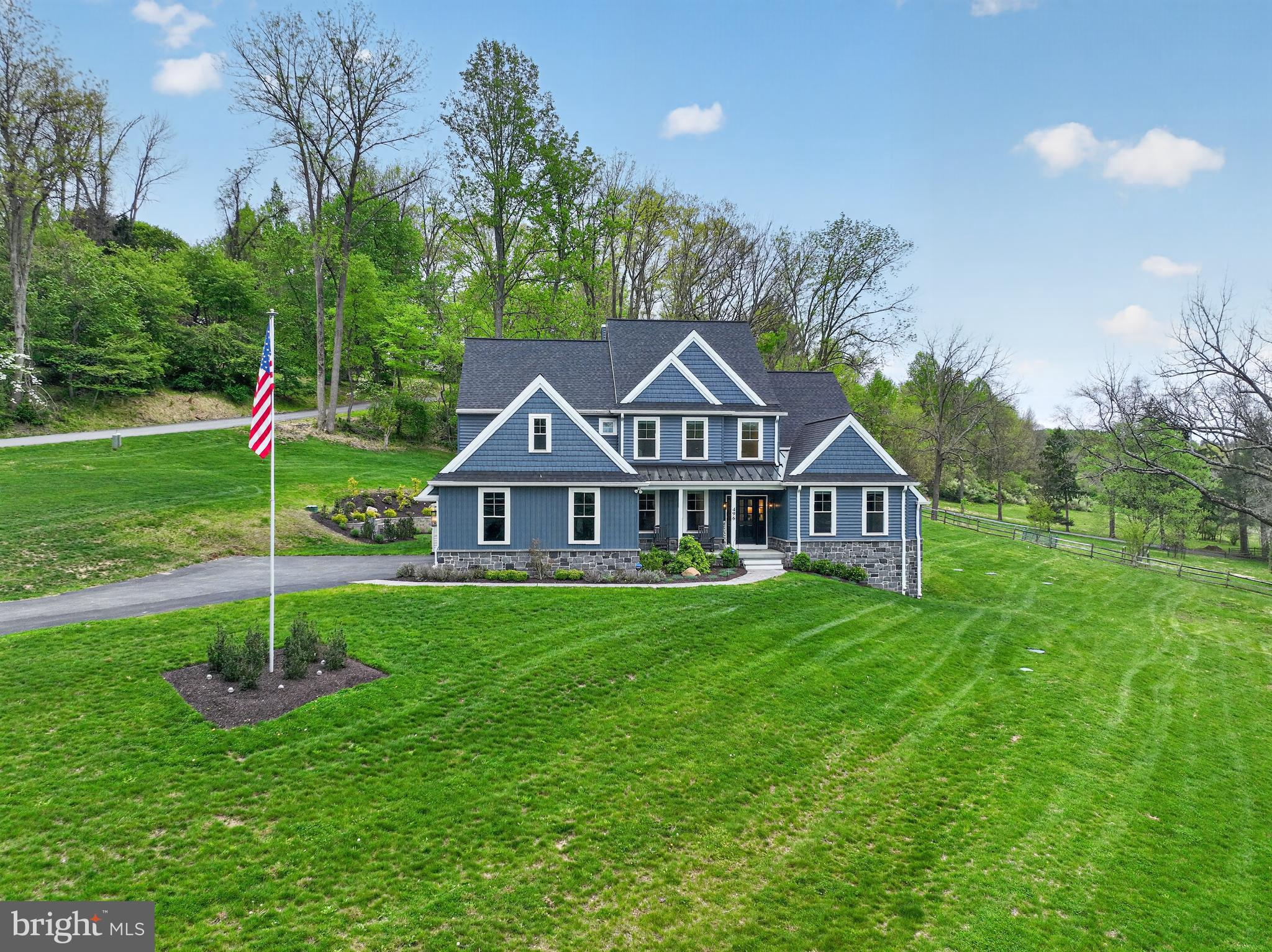 Set on almost 3 breathtaking acres in highly desirable Middletown Township, this exceptional custom-built home (built in 2023) offers the perfect blend of luxury, privacy, and timeless design. Perched gracefully atop a gentle hill, the property boasts stunning curb appeal and sweeping views of neighboring farms and serene ponds, creating a picturesque, estate-like setting.

The welcoming front porch is ideal for rocking chairs and quiet mornings. Inside, you’re greeted by a sun-drenched home office featuring expansive windows and generous closet storage, offering an inspiring work-from-home retreat. The formal dining room sits just off the entry, perfectly sized for hosting holidays and special gatherings.

The impressive two-story foyer flows seamlessly into a dramatic two-story family room, where large windows frame the scenic landscape and flood the space with natural light. A striking double-sided fireplace connects the family room to the heart of the home; the chef’s kitchen and breakfast area.

Designed for both everyday living and entertaining, the gourmet kitchen features GE Profile appliances, custom Century Kitchens cabinetry, a large center island, double ovens, and a statement hood vent. A stunning herringbone backsplash extends from the range to the ceiling, adding a sophisticated design element. Just beyond, doors lead to the patio and backyard, offering endless possibilities for outdoor living—with additional space to clear for even more usable land if desired.

Convenience meets functionality with a well-appointed mudroom and powder room located just off the kitchen, providing easy access to the three-car garage.

The first-floor primary suite is a true retreat, showcasing peaceful pond views, abundant natural light, a spacious custom-outfitted walk-in closet, and a luxurious en-suite bath with dual vanities and an oversized walk-in shower.

Upstairs, a thoughtfully designed layout includes a private “mini primary” suite with its own bath, two additional generously sized bedrooms connected by a Jack-and-Jill bathroom, and a versatile fifth room, ideal as a bedroom, playroom, or additional living space.

The walk-out basement offers incredible potential, already framed by natural light and scenic views, and ready to be finished to suit your vision whether it’s a home theater, gym, bar, or additional living quarters.

Additional highlights include luxury vinyl plank flooring throughout, a whole-house generator, a three-car garage with epoxy flooring, motorized window treatments, dimmable recessed lighting, a water softener system, and a full security system with cameras and remote access. A 12x20 shed sits on the other side of the driveway making it a convenient place to store lansdscaping tools, toys, etc. The roof and siding are both under transferable warranties, providing added peace of mind.

This is a rare opportunity to own a nearly new, thoughtfully designed luxury home in a truly idyllic setting, offering space, sophistication, and unmatched views. Other features include close proximity to all major routes (I-95, I-476, Rt 1), Walkable to Middletown's Trail System, Close to Ridley Creek State Park and a ton of parks/playgrounds. Located near Wawa & Elwyn SEPTA regional rail stations.