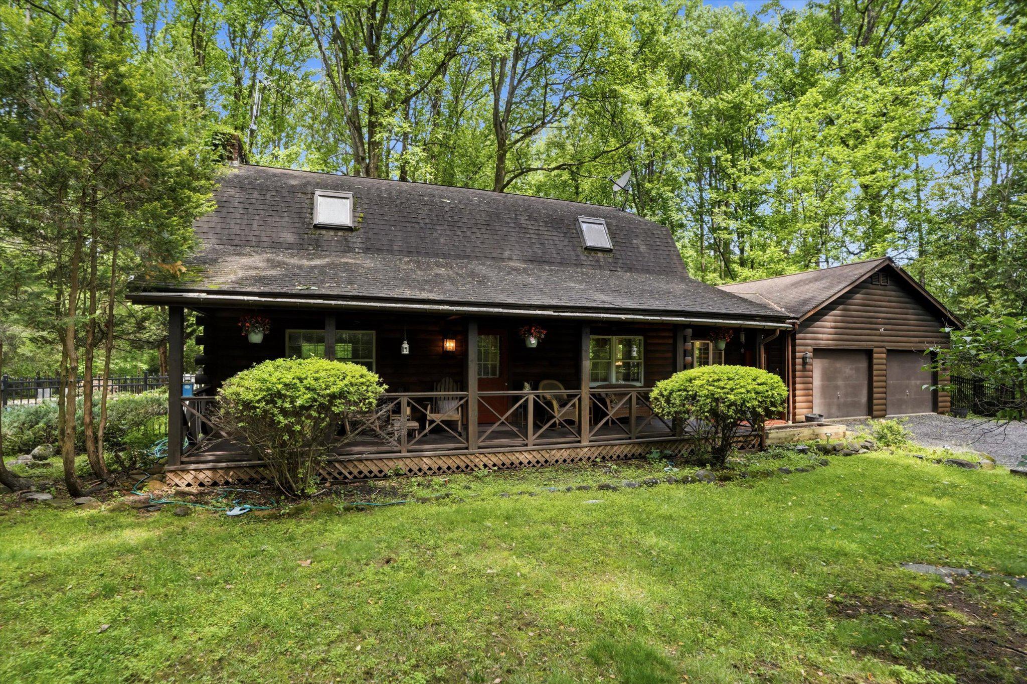 **Showings begin Thursday, 6/4**  Have you been searching for the kind of property that feels like a vacation without ever leaving home? Welcome to 607 Kulp Road, offering log cabin living on 2.15 private acres in Montgomery County. Set against a wooded backdrop, this 3-bedroom, 2-full-bath home offers a rare combination of privacy, character, and outdoor living that's made for both entertaining and unwinding.
Step inside and you'll feel right at home, where rustic charm, exposed wood, and warm finishes create a space that's genuinely inviting. The kitchen anchors the main level with a large island, butcher block countertops, and a range hood — a space that works equally well for weeknight dinners and weekend gatherings. The adjacent dining room offers flexibility, working equally well as a sitting area depending on your needs. Beyond that, the generously sized living room centers around a gas fireplace, with wood floors and walls that give the space an authentic, lodge-inspired feel. A full bathroom on the main floor adds welcome convenience. Upstairs, the spacious primary bedroom accommodates a king bed and offers two large closets, with two additional bedrooms and a full hall bath completing the second floor. The basement rounds out the home with high ceilings and real potential, whether you envision finished living space, a workshop, or additional storage.
Step outside and you'll feel like you've traded the rest of the world for your own private retreat. A deck off the main living area is made for grilling and warm weather gatherings, with tree views in every direction that make it feel worlds away. Additional patio spaces offer room to spread out, whether you're hosting a crowd or simply looking for a quiet corner to settle into. The in-ground pool and hot tub anchor the outdoor space, with a poolhouse just steps away for storage. Beyond the pool area, the wooded lot stretches out and reminds you why a property like this is hard to walk away from. Whether you're envisioning summer evenings by the pool or a quiet weekend with nowhere to be, this home makes it easy to do both.
Situated within the Boyertown Area School District and just minutes from Green Lane Park, the location is as much a draw as the property itself. Green Lane Park spans over 3,400 acres with 25 miles of trails for hiking, mountain biking, and horseback riding, plus fishing, boating, camping, and cross-country skiing in winter. The Perkiomen Trail runs directly through the park, connecting south through Montgomery County all the way to the Schuylkill River Trail. When you're ready for a night out, Skippack Village is a short drive away, offering locally owned restaurants, boutique shopping, and a calendar full of community events. Properties like 607 Kulp Road don't come along often. Quiet, private, and genuinely connected to everything Montgomery County has to offer, this one is worth a closer look. If this sounds like your kind of home, schedule a showing today.