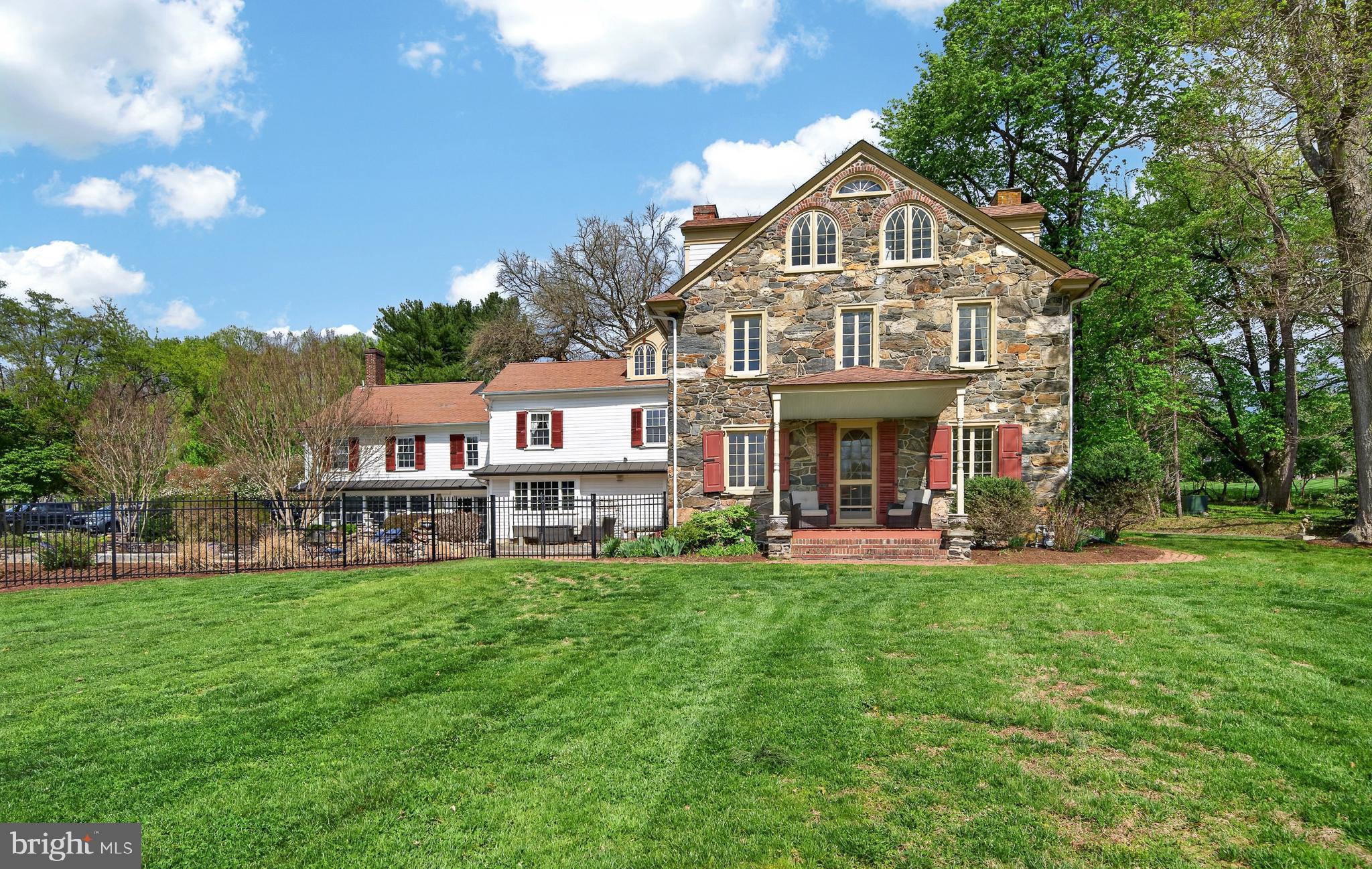 Antique home enthusiasts must see this historic c.1731 treasure! Set on 14.2 private acres, this 5 bedroom, 4.1 bath home is set well off the road. Its earliest owners probably watched the British army march by on its way to participate in the Battle of the Brandywine. An interesting detail is that the next owner of this wonderful farm will be only the fifth owner in its long history! Most of the home features well preserved details like original wood flooring, numerous fireplaces with their original mantels, deep window sills, and antique hardware. Wherever possible the current owners have incorporated many of these details in the additions to the home. For instance, the newer Sun Room features a pair of serpentine stone pillars that were part of a barn once located there. One of the home’s most unique treasures is the pencil sketch silhouette of George Washington that was drawn on the original plaster wall in the study. The Living Room, part of the original home, features a high ceiling, unusual for a home of this vintage. Many of the home’s windows offer a southerly exposure which floods their rooms with natural light. The Dining Room is a treasure by itself! The floors are particularly handsome, and the room features the original fireplace and mantel plus original cabinets. Off the Living Room is a Butler’s Pantry with antique cupboards and leads to the spacious Kitchen with high-end Thermador appliances, custom cabinets, center island and lots of soapstone counters. Off the Kitchen is the large Sun Room with a wall of south facing windows. An atrium door offers access to the large brick patio and in-ground pool. You will also find a full bathroom here, ideal for those desiring to shower after a dip in the pool. The Primary Suite features a luxurious Primary Bedroom, a Walk-in Closet, plus a lovely bath added in 2019. Amidst all the newer improvements, the Primary Bedroom retains its original fireplace and mantel along with period flooring and windows. There are four additional family bedrooms and two modernized bathrooms. The finished third level is in excellent condition. A wonderful feature is the five room Office with an exterior access from a porch along the driveway. This space could easily accommodate a fabulous in-law or guest suite! Other farm amenities include a three bedroom Cottage plus a large tractor/equipment barn. Equestrians will love the four stall stable with a tack room. There are also four fenced fields complete with water and electric, one has a large run-in shed, a round pen and a riding ring. This property is convenient for commuting to Wilmington and only 45 minutes from the Philadelphia airport. The bustling restaurant scene in West Chester is a mere 10 minutes away. Rarely does a historic home of this vintage and uniquely private location come on the market. Don’t wait too long!