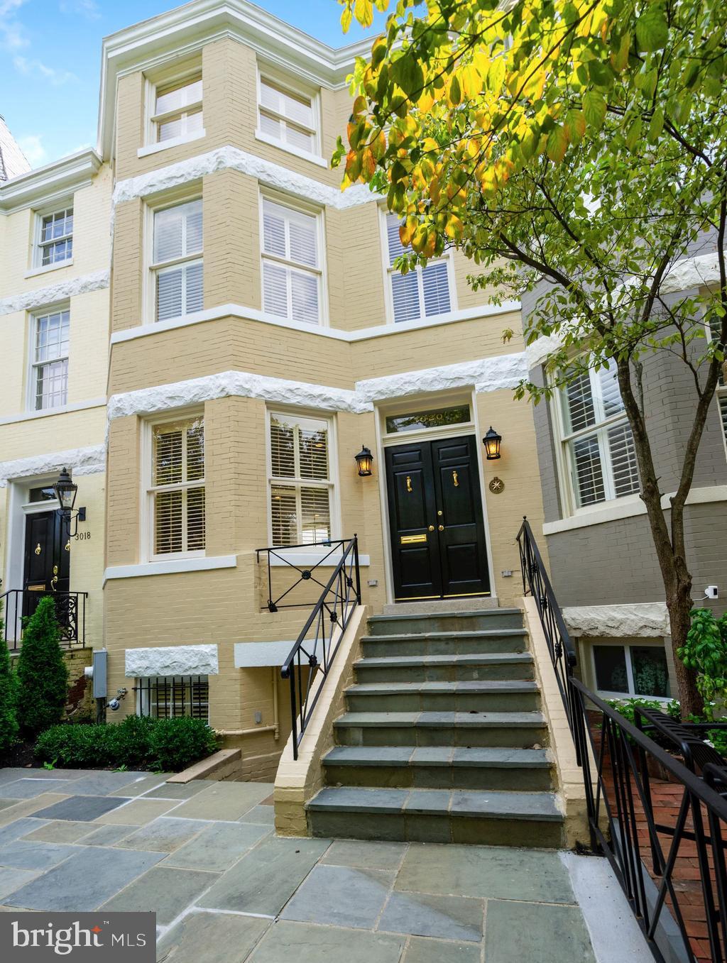 PRICE ADJUSTMENT! Large and wide, fully restored townhouse with 2 CAR PARKING and lower level suite with separate entrance perfect for home office/ gym,  playroom  or nanny . Renovation/restoration of both interior and exterior just finished in June 2020 including a new heating system, a new AC and new water heater. The First Floor design is open and gallery-like with 9+ foot ceilings and a double living room with antique pine wood floor, atrium windows, fireplace, and  gourmet kitchen with custom cabinetry and granite counters. The Upper Level boasts an owner's suite with 13-foot ceilings and large walk-in closet plus two additional bedrooms each with ensuite bathrooms, all featuring great natural light. The Lower Level offers a complete au-pair suite (or office/. gym) with private front and rear entrances, living room, a full kitchen, private laundry, bedroom and storage rooms. There is a charming flagstone above patio with new landscaping at the front of the house and two parking spots in the rear.