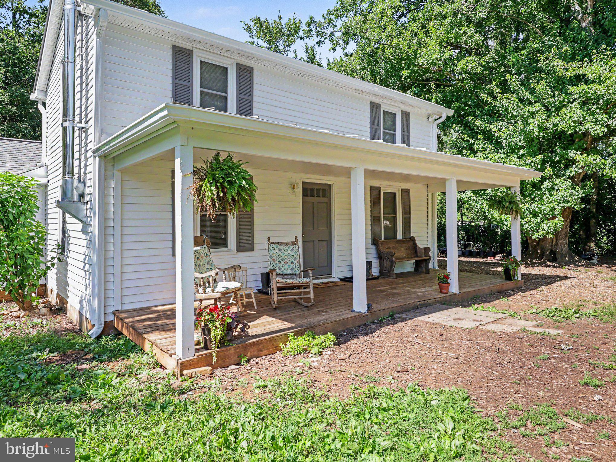 Charming updated 1910 3-bedroom, 2-bathroom farmhouse situated on 6 picturesque acres, thoughtfully developed into a fully functional homestead and working farm. This unique property offers endless possibilities for hobby farming, livestock, gardening, or small farm business operations. 

Explore the timeless elegance of Virginia-milled ash wood floors made by Willow Run Lumber in Rockingham, VA. These stunning floors are characterized by their remarkable grain and warmth.  Complementing this architectural feature is an exceptional wood stove, meticulously crafted in Monroe, VA. 

This property features a 2-story barn built in 2013 with 2 stalls, a washroom with hot/cold water, a workshop/tack room, an office space, a storage room, and a livestock handling area. Additional improvements include a separate Farm Store building on its own electric meter, with a covered porch, refrigerator/freezer space, and a generator transfer switch, making it ideal for agricultural or business use. The land is fully perimeter fenced, with two pastures, hydrants, established garden areas with rich organic soil, two hoop-style greenhouses, raised garden beds, a chicken coop with enclosed run, mobile poultry coop, and multiple storage sheds. 

The property also includes a wide variety of established fruit trees and berries, including apple, pear, peach, plum, cherry, blueberry, raspberry, blackberry, elderberry, and figs. Additional features include a high-tensile woven-wire perimeter fence, rain water catchment for gardens, a back-up stainless steel Bison deep well hand pump, 50-amp RV/electric hookup, covered front porch, and a blend of historic charm and modern farm infrastructure. This is a rare opportunity to own a turnkey homestead property with extensive improvements already in place. Property is in agricultural use.
This property is a working farm and home is occupied. Appointment required. Please do not go onto the property without an appointment.