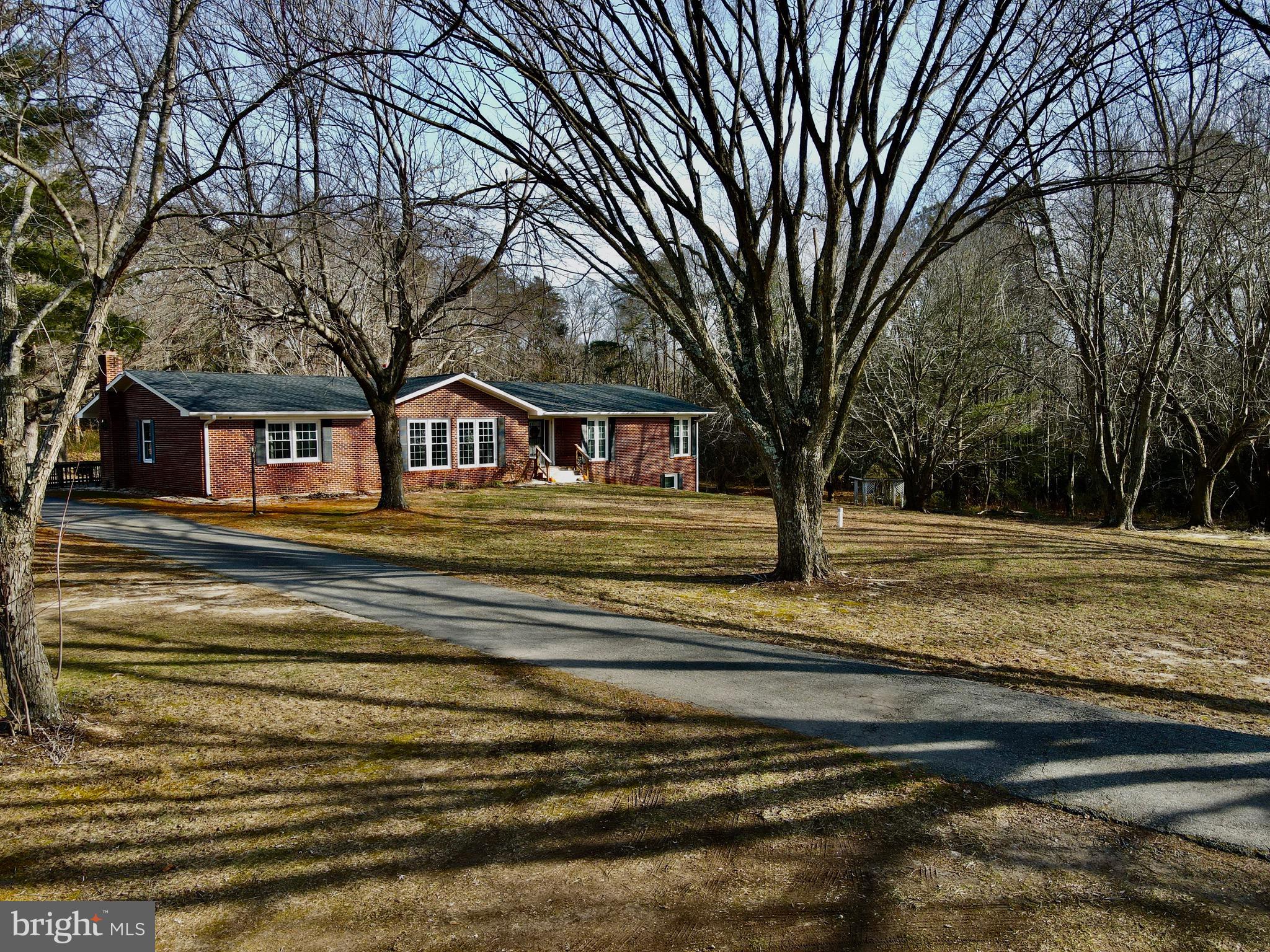 Additional photos available soon - Beautiful brick rancher with basement on + 2.36 acres offers spacious rooms.  Main level - Eat-in kitchen, Living Room, Family Room with Fireplace, Dining Room, Office with Fireplace, Primary Bedroom suite with bath, two additional bedrooms, Full Bath, Storage closet/pantry, Washer/Dryer closet located  in Office.  Lower level/walk-out basement - Recreation/Entertainment Room with Fireplace, Bedroom, Bath, Den, Storage closet, Workshop.  Asphalt Driveway. Deck, Patio, 2022 Roof shingles.  Gardening area.  Nearby - Restaurants, Shopping, Marinas, Boat Launches, vineyards/wineries.