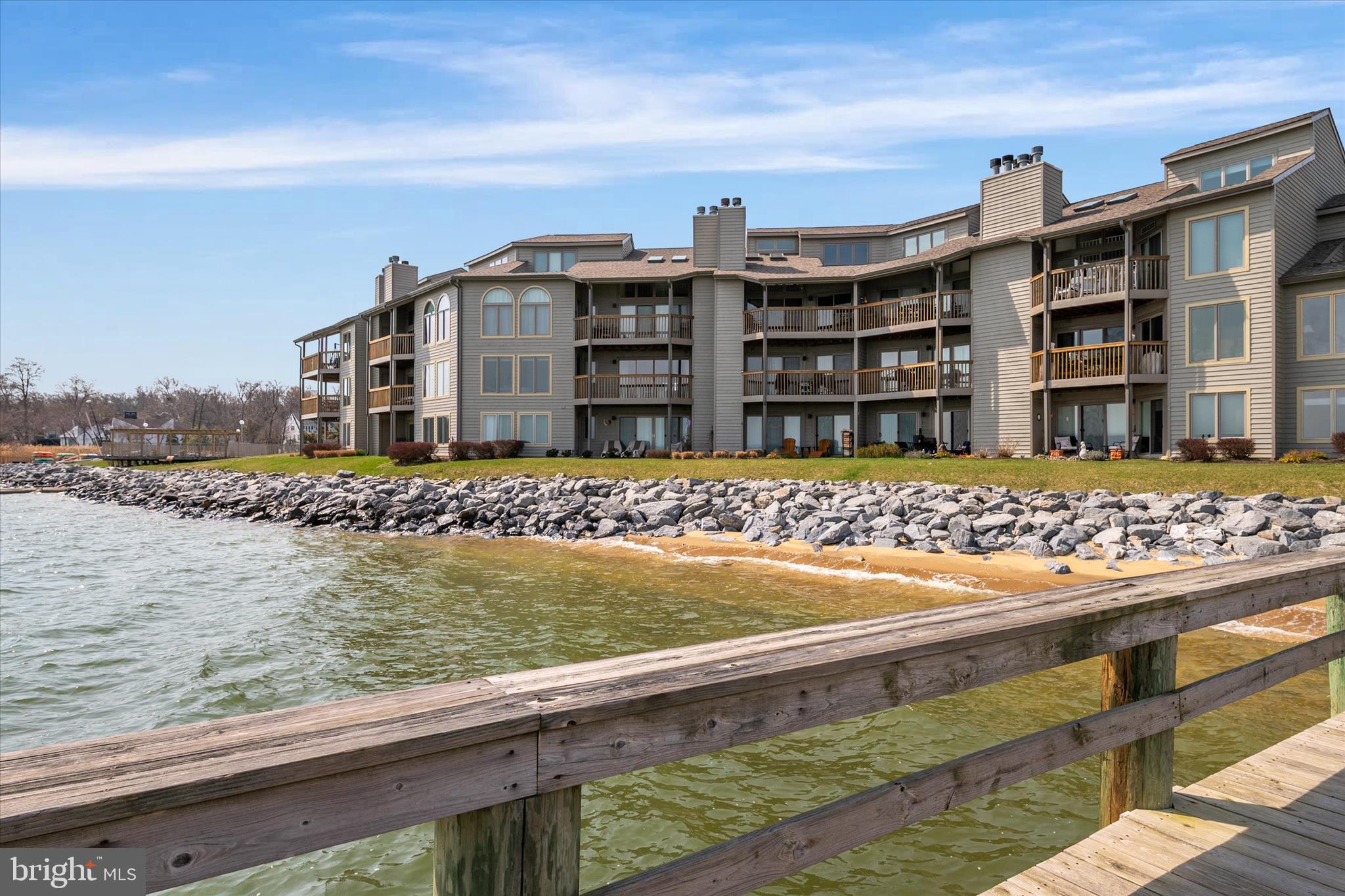 OFFER DEADLINE FOR MONDAY, 3/30 AT NOON. Please submit all highest and best offers by then. Welcome to 2129 Beach Village Court #101, a beautifully updated 2 bedroom, 2 bath waterfront condominium in the highly sought after gated community of Chesapeake Harbour. Freshly painted with new luxury vinyl plank flooring, this light filled residence offers a serene coastal retreat just minutes from Downtown Annapolis. The thoughtful home is designed with both comfort and entertaining in mind, featuring a spacious open layout that connects the living room, dining area, and kitchen. The well-appointed kitchen offers stainless steel appliances along with abundant cabinet and counter space, creating a space that is as functional as it is inviting for gathering with family and friends. Enjoy tranquil Chesapeake Bay views from both the living space and private deck, where gentle breezes and expansive water vistas create the perfect setting for relaxing mornings and peaceful evenings. The primary suite offers direct access to the deck and features a spa inspired bathroom along with generous closet space designed for comfort and convenience. Life at Chesapeake Harbour is truly exceptional. Residents enjoy gated entry security, waterfront pools, marina access, tennis courts, private beach access, scenic walking trails and waterfront dining at the beloved Beacon Waterfront Bar & Grill. Sit on the balcony and get a front row view of the Annapolis boat races, the downtown Annapolis fireworks display on the 4th of July and the Navy Blue Angels flyover that happens during the Naval Academy’s graduation ceremony. All of this is just a short drive to the shops, restaurants and the historic charm of Annapolis. A rare opportunity to enjoy resort style waterfront living in one of the area’s most coveted communities.