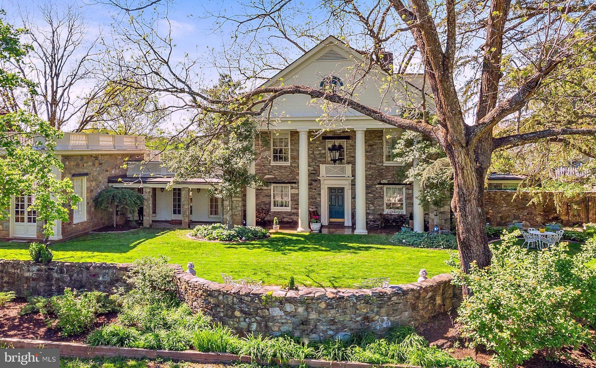 Entered into the National Register of Historic Places (2014), Holly Hill has welcomed distinguished guests such as Walt Disney, Elizabeth Taylor, and many prominent government ofﬁcials over the years. This gracious stone manor has been meticulously maintained to honor the many original and irreplaceable 18th/19th century features: carved period molding, wood beam ceilings, stone ﬁreplaces, and antique heart pine ﬂoors, w/tasteful upgrades and luxury ﬁnishes added throughout. Ancient Oaks, Maples, and Walnuts shade the English gardens and stone walkways.  Beautifully sited for tranquility and privacy, just ﬁve minutes from Middleburg, Holly Hill comprises an easily manageable 37+ acres in three separate tax parcels. Only the third time on the market in almost 80 years, a rare opportunity to own a treasured piece of history. The classical entrance with Tuscan Columns, Chippendale molding, and Belgian marble ﬂooring leads through the parlor to the fully remodeled chef’s kitchen w/imported French Lacanche range, custom cabinetry, Enkeboll moldings, and new appliances to complement the historic stone ﬁreplace, antique brick ﬂoors, and wood-beam ceilings. The Family Room overlooks the private lake and pastures, with Jotul wood stove and original stone walls. The Grand Ballroom has 11’ ceilings, Period molding, and double French doors opening onto English gardens. The second ﬂoor Main Suite has French doors onto a romantic Juliet balcony, private 29‘x23’ rooftop terrace, separate bathrooms with marble shower and antique cast-iron soaking tub, antique pine-paneled library with ﬂoor-to-ceiling bookcases, laundry with cedar closet, and a cozy room with private Dutch door entry. The upper level has three charming bedrooms, affectionately named the “Lake-view, Stable-view, and Pond-view.”  The European courtyard horse stables have six+ 14‘x18’ stalls, paddocks, tack room,  hayloft, and workshop. The studio above the barn has wood ﬂoors, mirrors, ballet barres. There is additionally a tenant apt and farm ofﬁce, both w/bedroom, full bath, kit, laundry. The charming one-bedroom cottage with a full kitchen, bath, & laundry adjacent to the pool is currently a popular AirB&B or future guest/family suite. The ﬁelds are fenced for rotational grazing, heated waterers, run-in shed with FEI dressage arena sited for a future enclosure, separate 100’ x 200’ grass arena, X-country course. OCH hunt territory, extensive ride-out. Internet access on-site. Starlink reserved (300 Mbps). Conservation easement potential. “Vineyard Site Evaluation Report” 17.3946 acres 96% Suitable” for grapes.