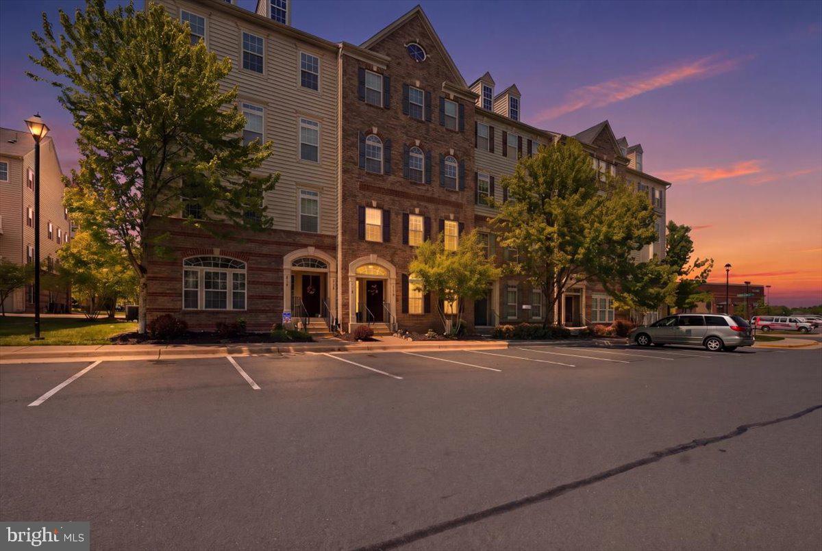 A beautifully maintained 2-level condo offering the perfect blend of modern upgrades, functional living space, and an unbeatable location. This 3-bedroom, 2.5-bath home features 1,642 square feet and a bright, open, airy floorplan designed for today’s lifestyle. The main living area showcases upgraded engineered hardwood floors and elegant crown molding throughout, creating a polished and cohesive feel. The stunning kitchen is the heart of the home, complete with an island, granite countertops, stainless steel appliances, rich brown cabinetry, and stylish teardrop pendant lighting—perfect for both everyday living and entertaining. There is a convenient half bath off the Kitchen and then walk outs to a spacious garage with ceiling fan. Upstairs, the huge primary suite offers a tray ceiling, ceiling fan, a walk-in closet outfitted with California Closets, and a beautifully upgraded en-suite bath with dual vanity, upgraded tile floor and separate tub and shower. Two additional bedrooms provide flexibility for guests, home office space, or hobbies, with a private balcony accessible from the third bedroom. Ceiling fans are thoughtfully installed in all bedrooms and the living room for year-round comfort. Enjoy the convenience of a 1-car garage and lots of open parking, plus a home that has been exceptionally well cared for. The community offers desirable amenities including a pool, tot lot, and walking trails—ideal for relaxation and recreation. Located within walking distance to Heathcote Plaza (featuring Harris Teeter, restaurants, and shops) and Heritage Village Plaza (offering medical services, fitness centers, preschools, and more), this home also provides quick access to Interstate 66, making commuting a breeze. This move-in ready home truly has it all—style, comfort, and a prime Gainesville location.